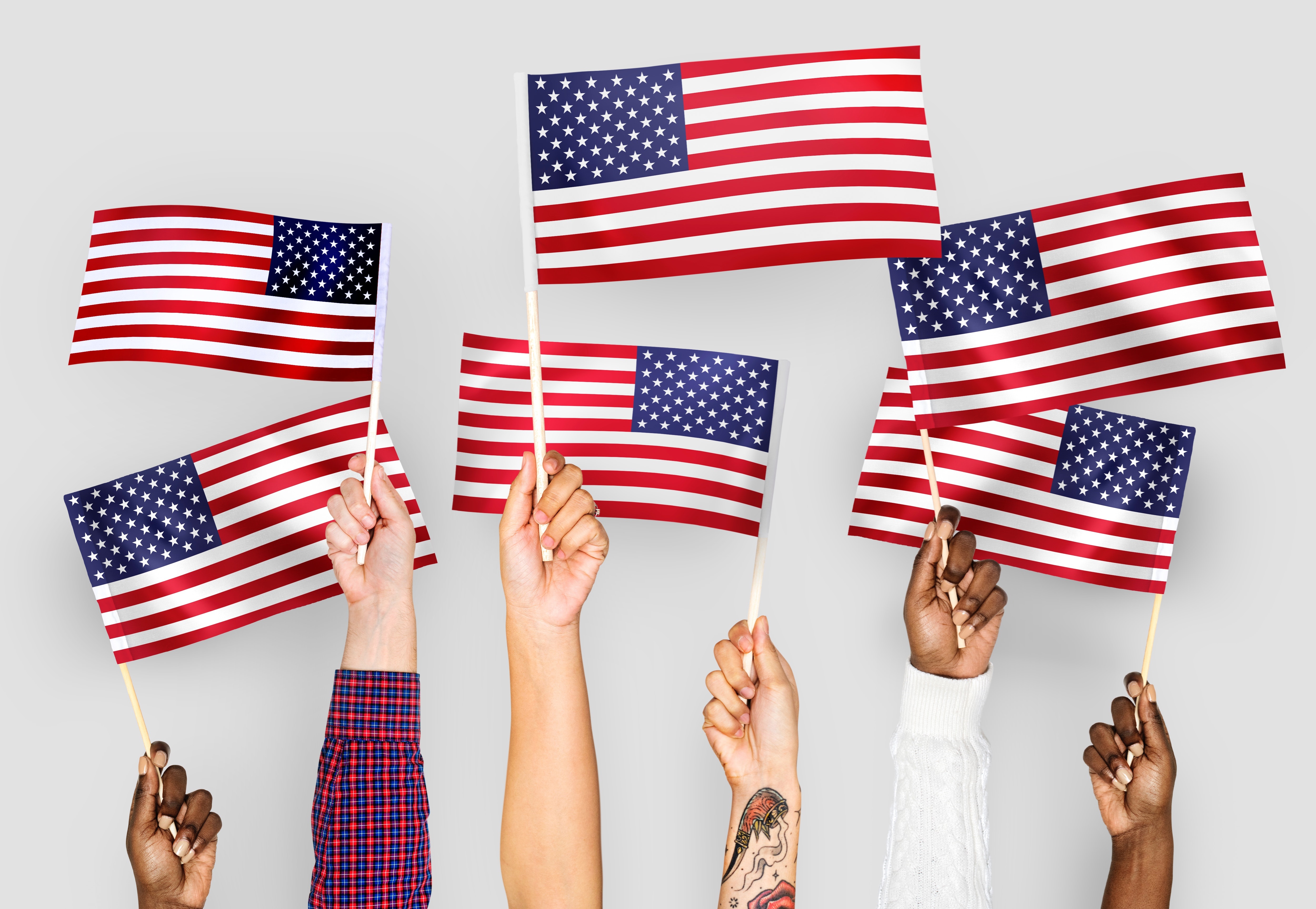 Hands holding up American flags