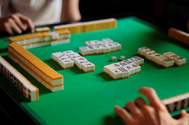 mahjong tiles on a green felt game board