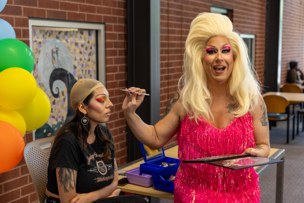 Image: Evanna Madonna doing drag make-up on a library patron