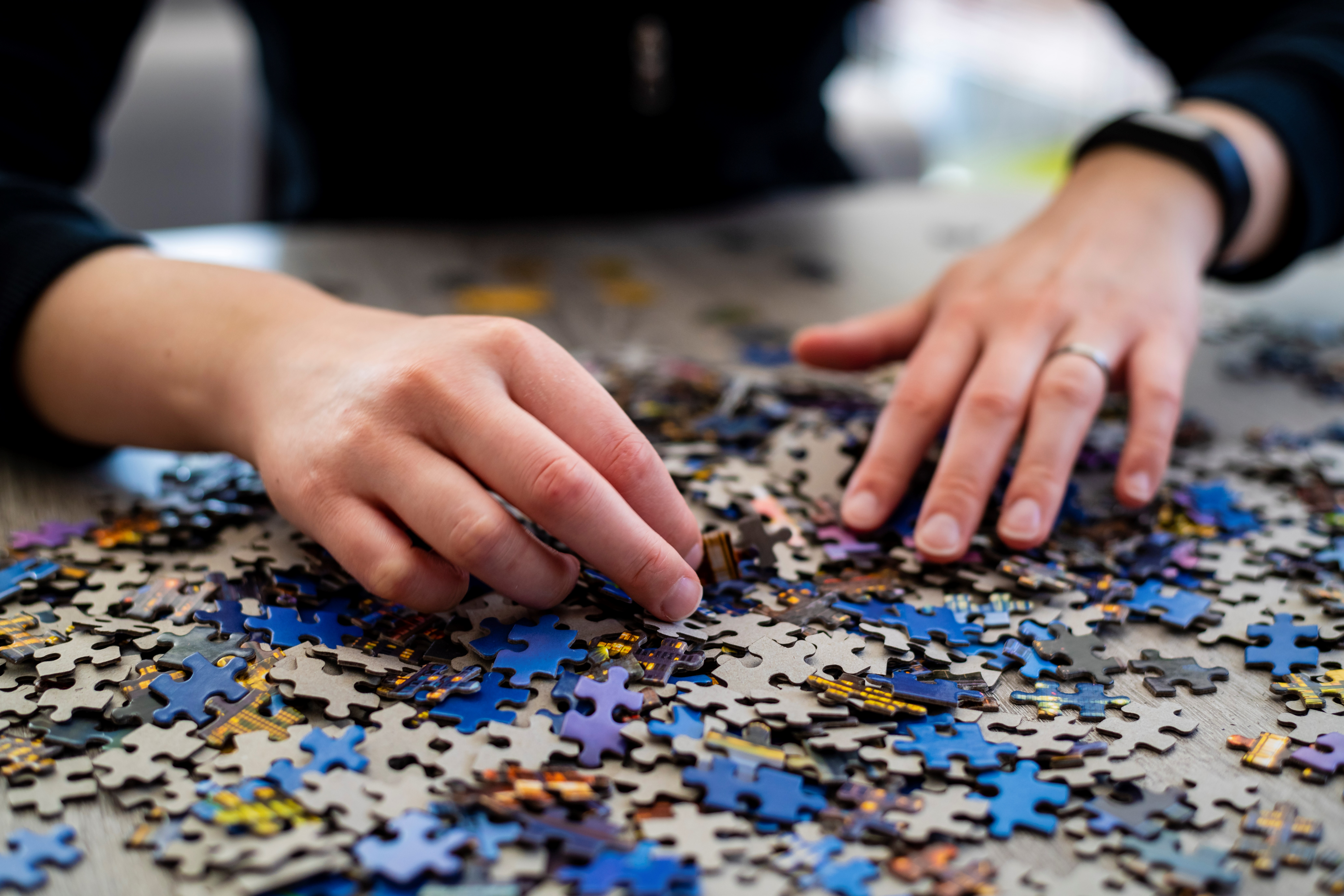 Person Putting a Puzzle Together