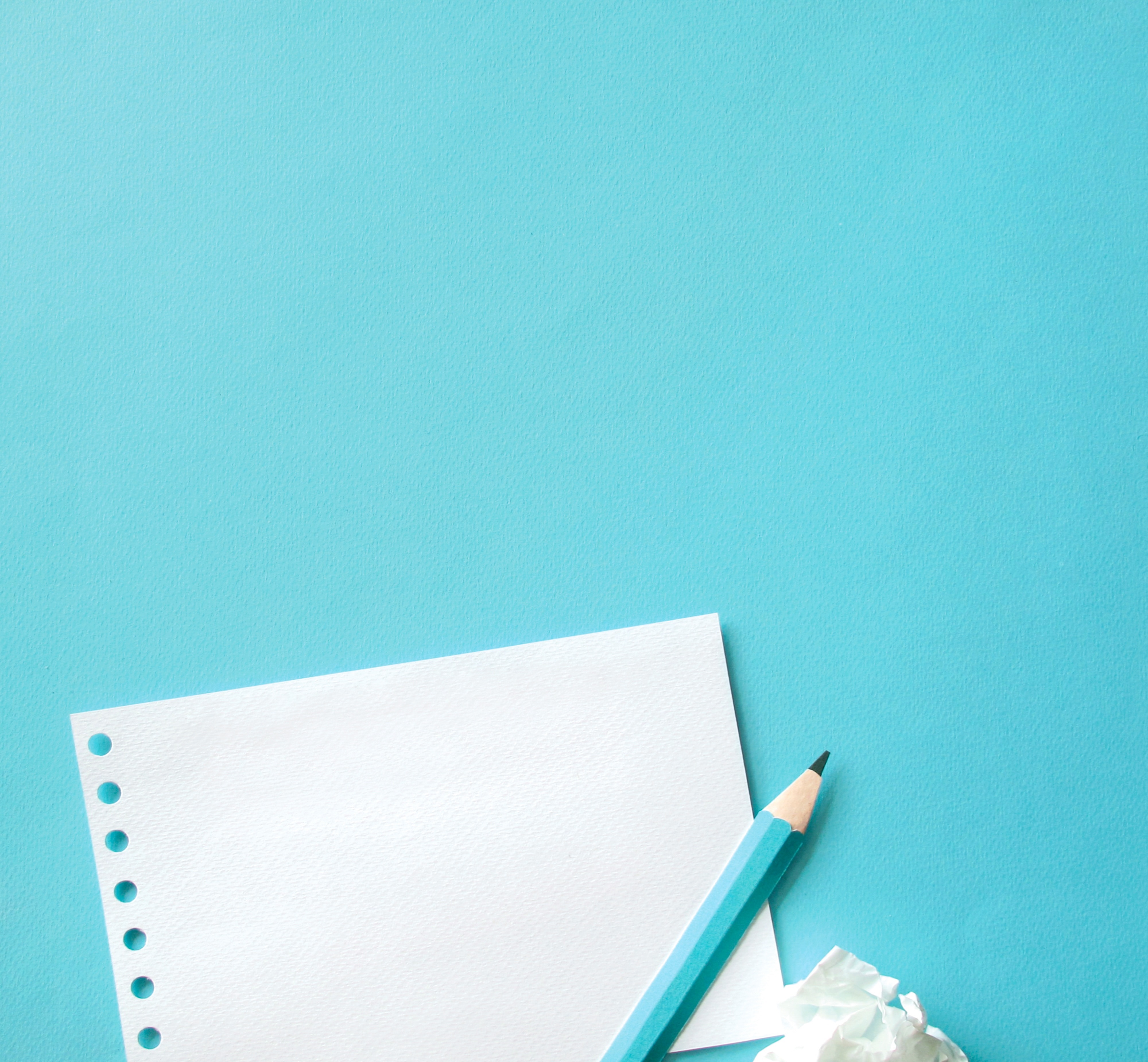 Paper and Pencil on Blue Background