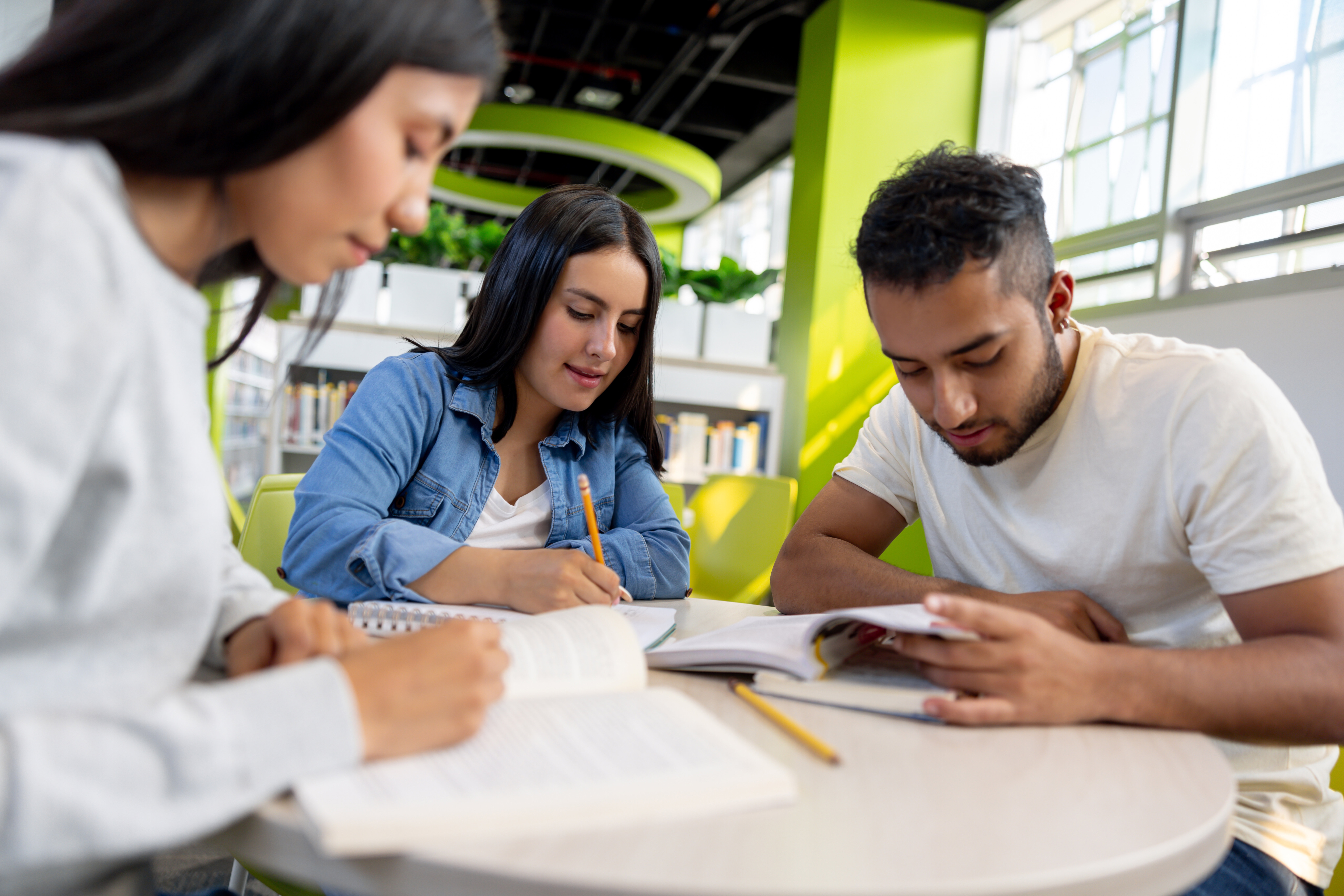 Group Of Students Studying Together At The Library