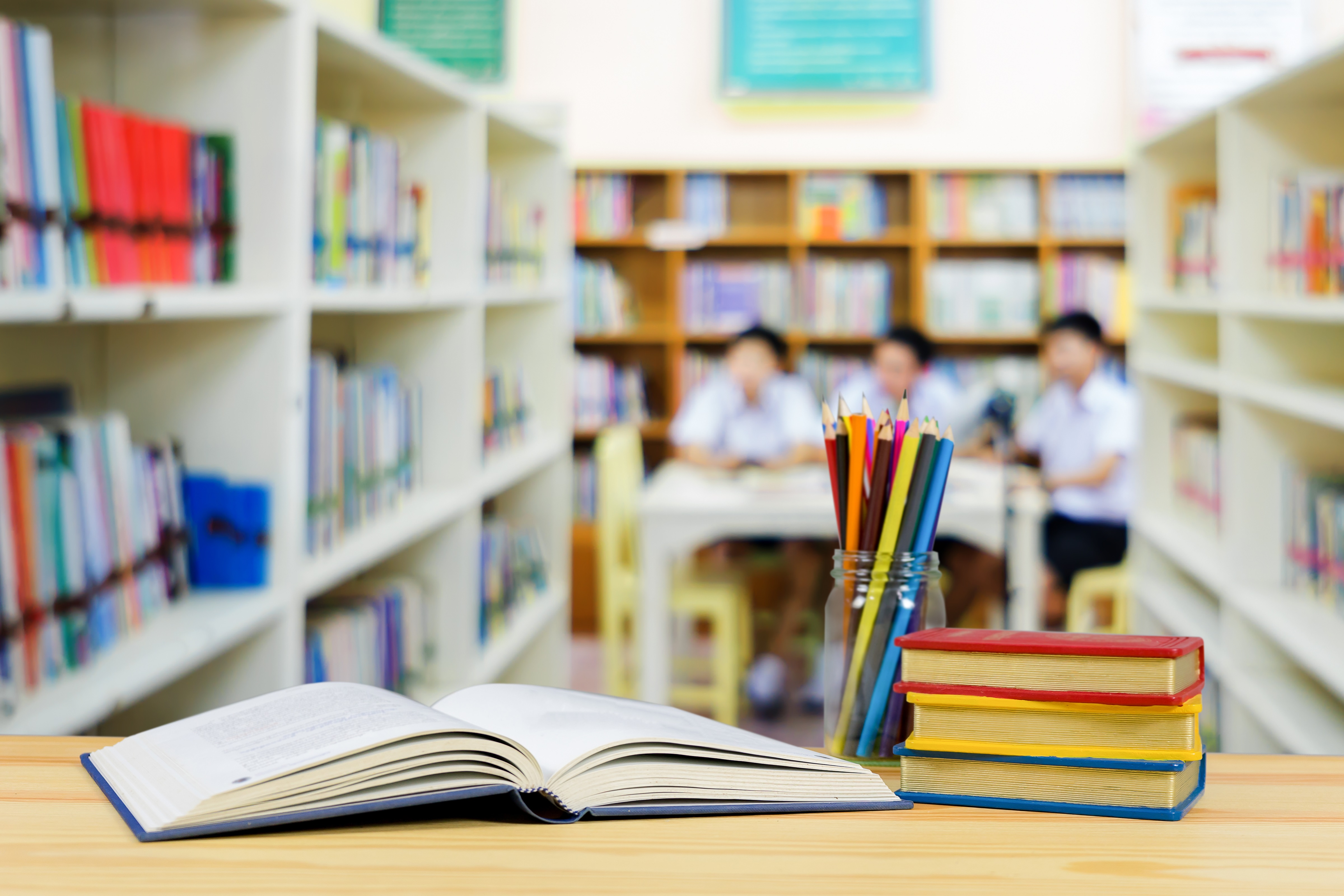 Books on the Table and Students in the Library
