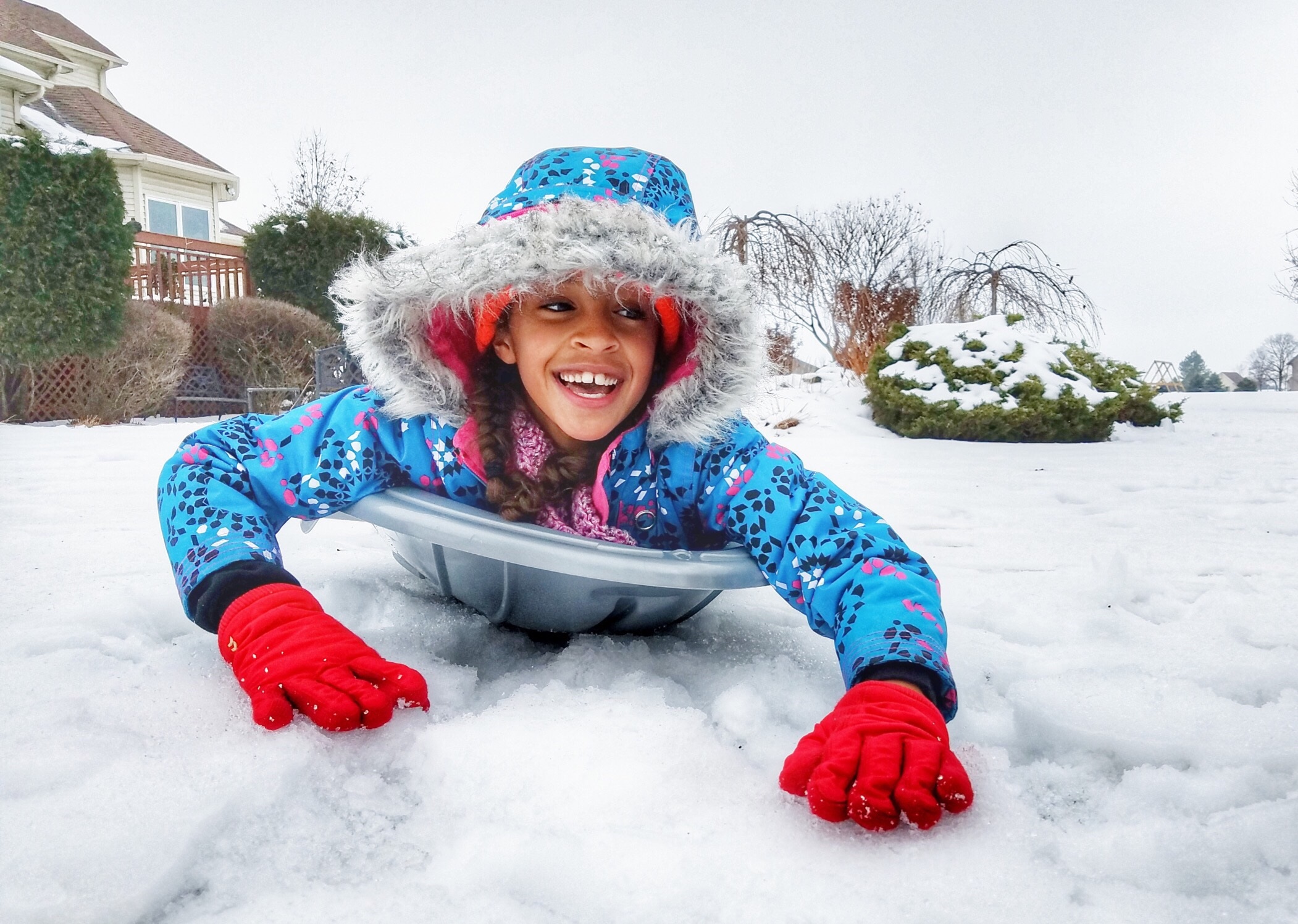 Girl sledding on snow