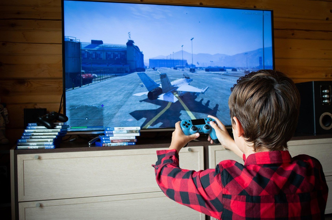 A photo of a child playing a video game. 
