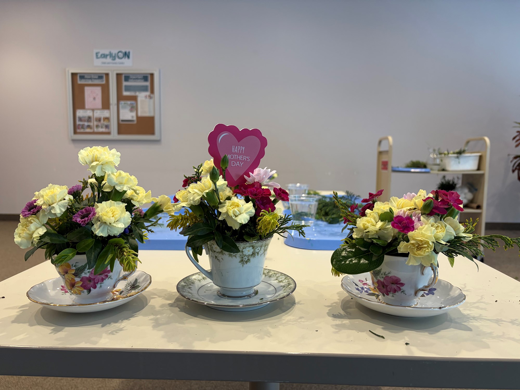 Floral centerpieces in tea cups.
