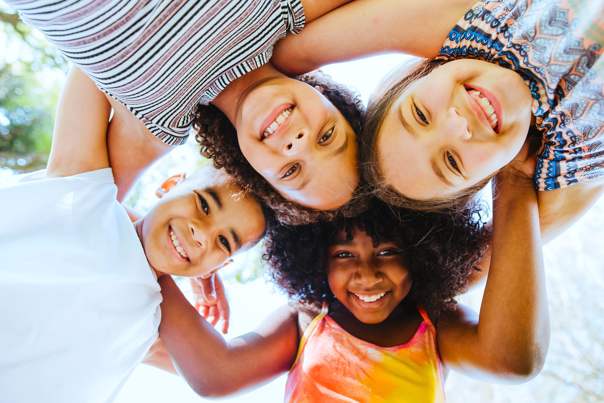 A group of four smiling children.