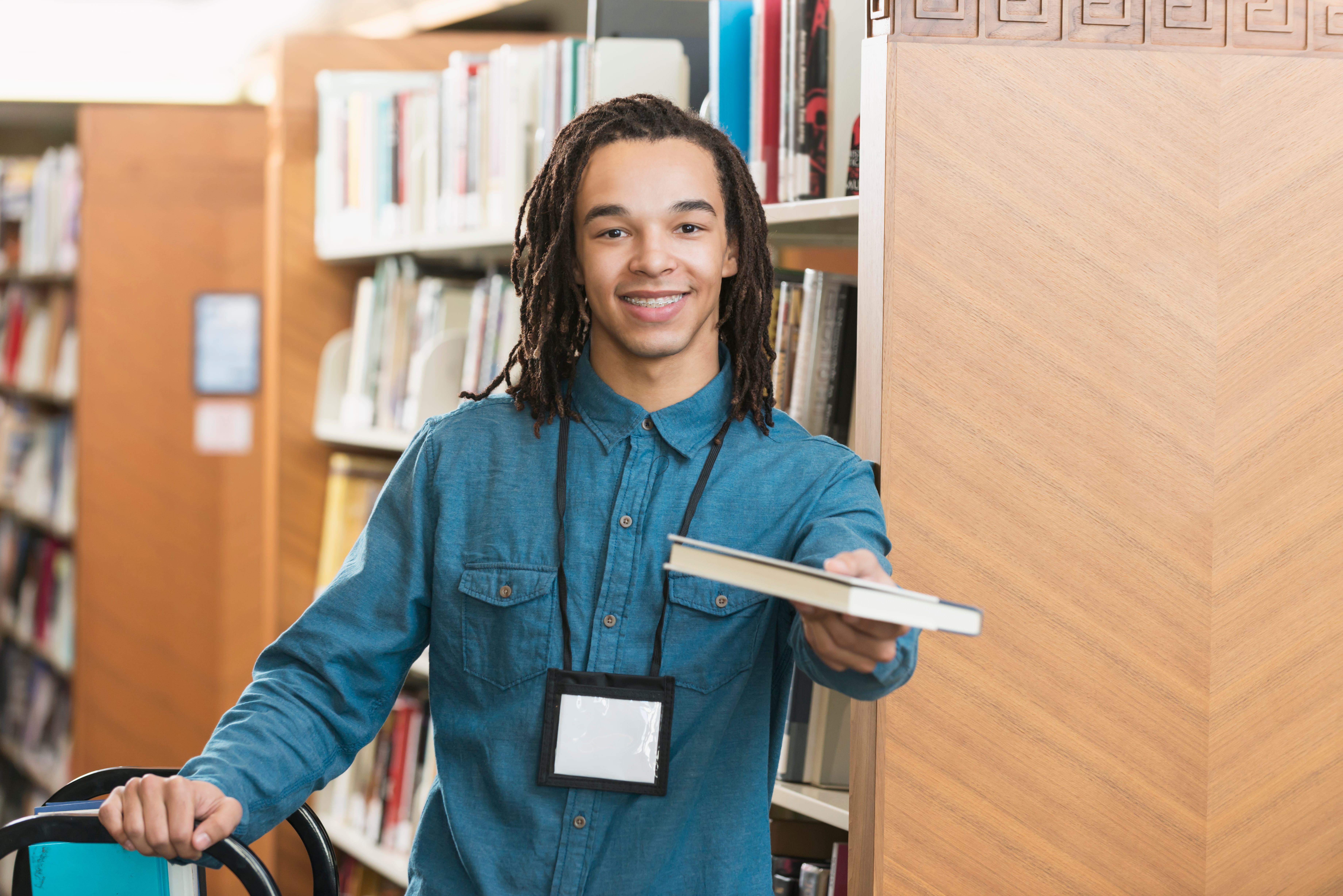 Young man working at the library