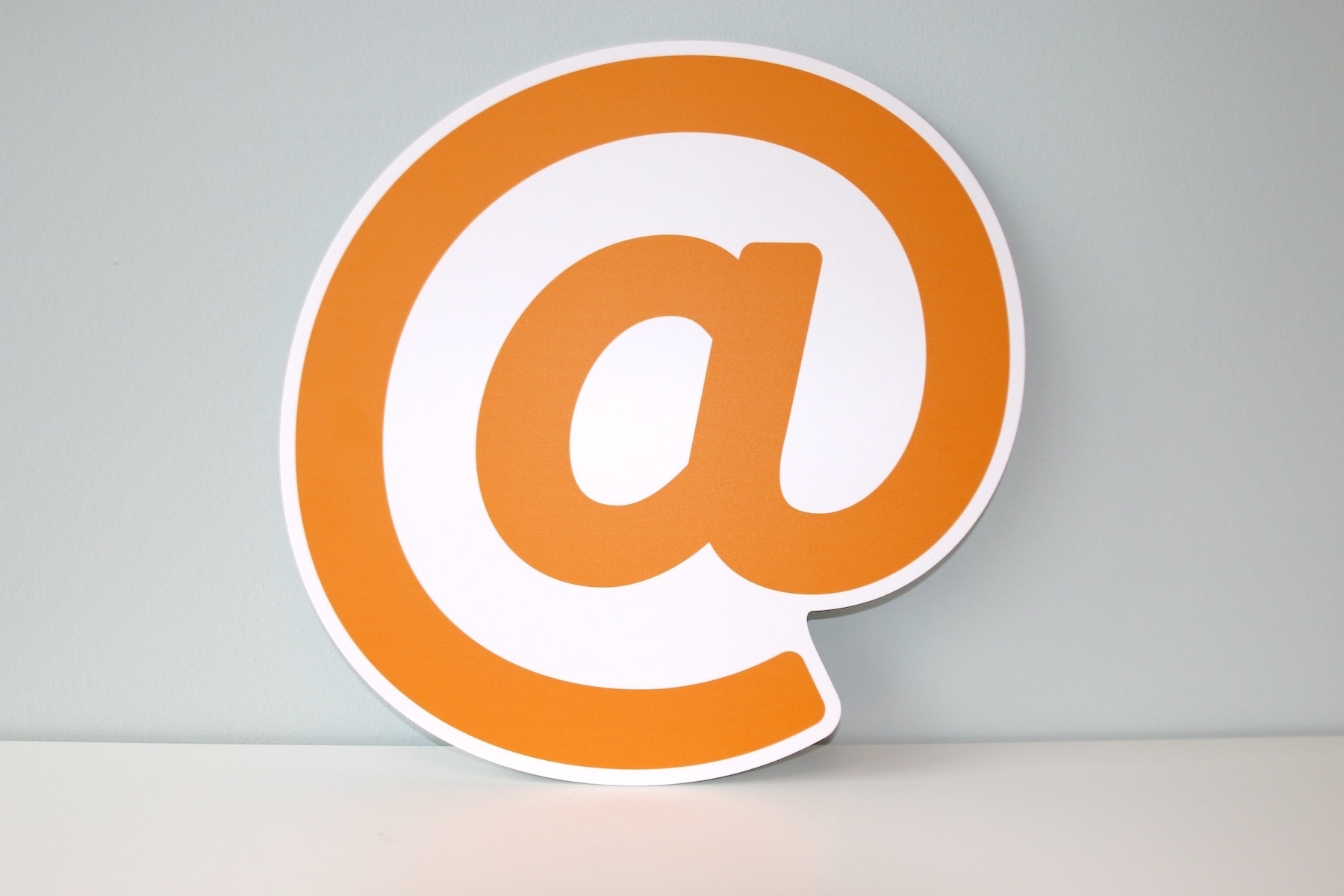 Orange @ Symbol on Gray Background