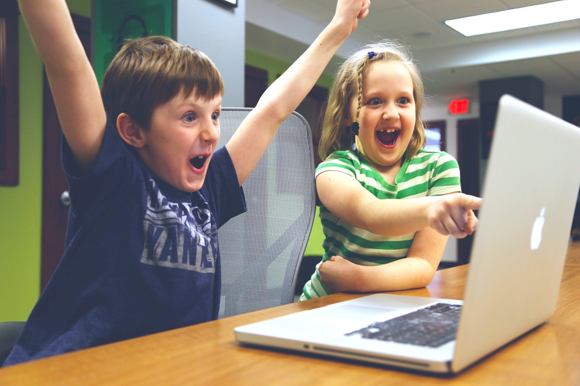 School Kids Girl and Boy Playing Games on Laptop Technology