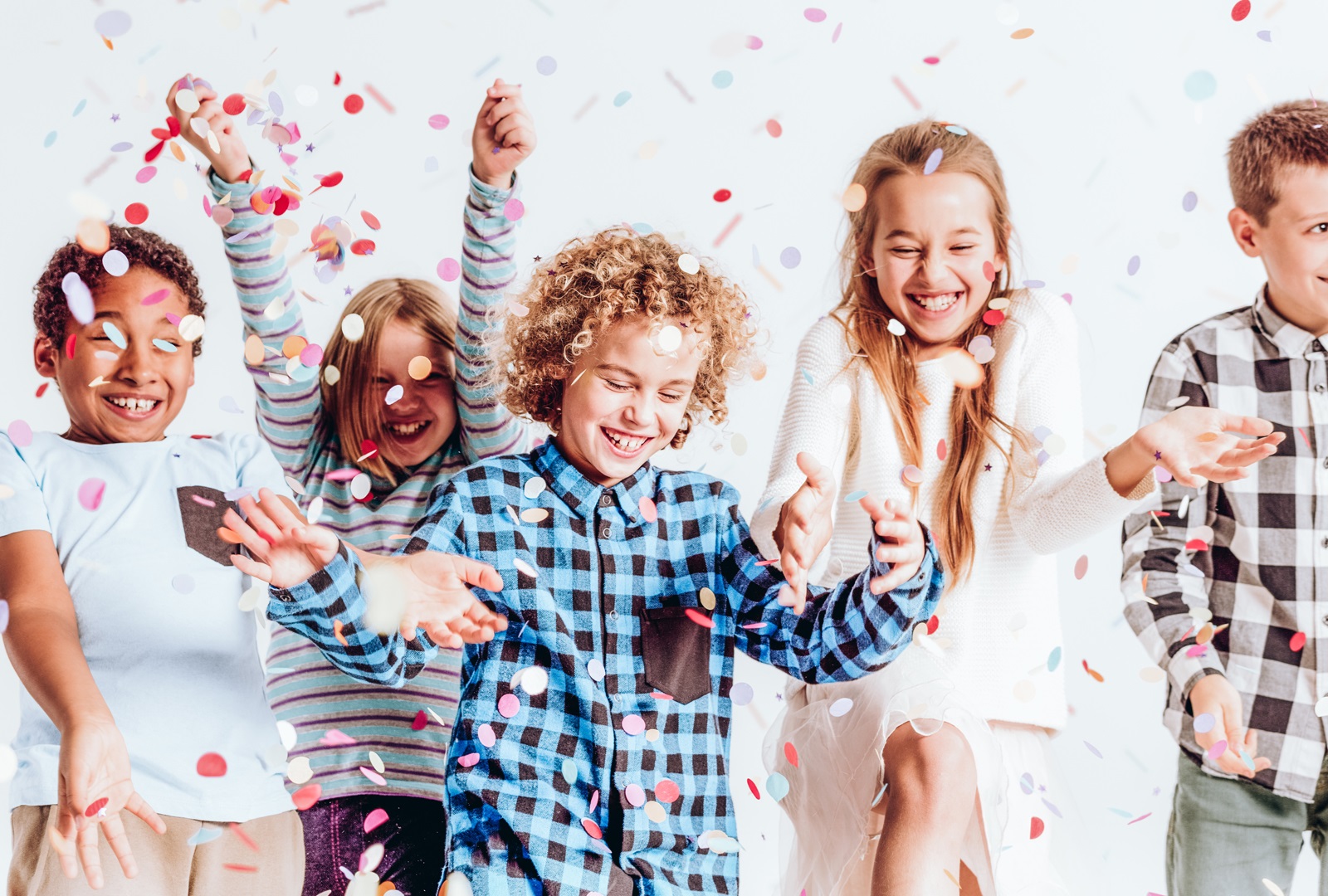 Children dancing in confetti