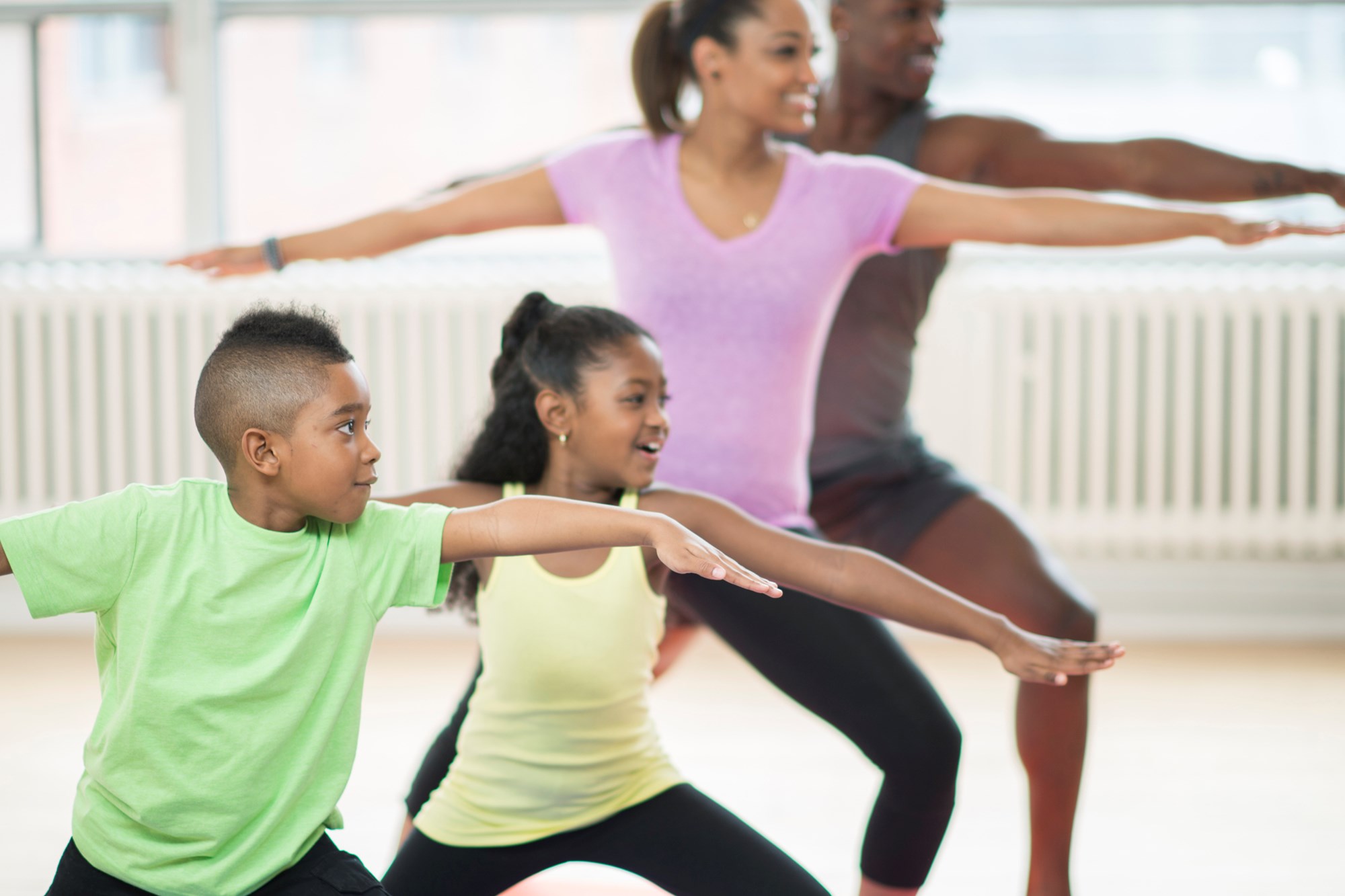 Family of Four Doing Yoga Indoor