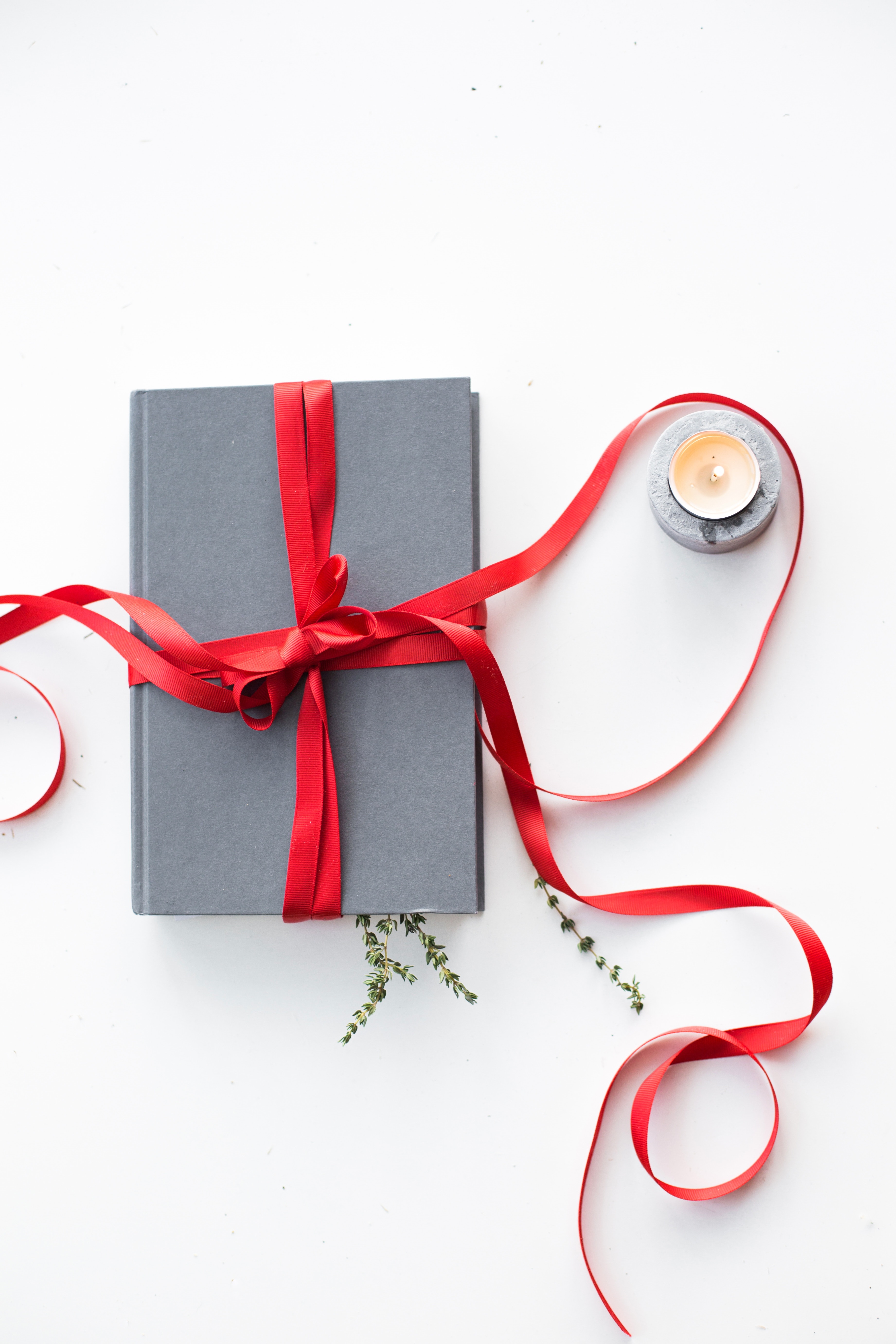 Gray Book with Red Ribbon on White Background