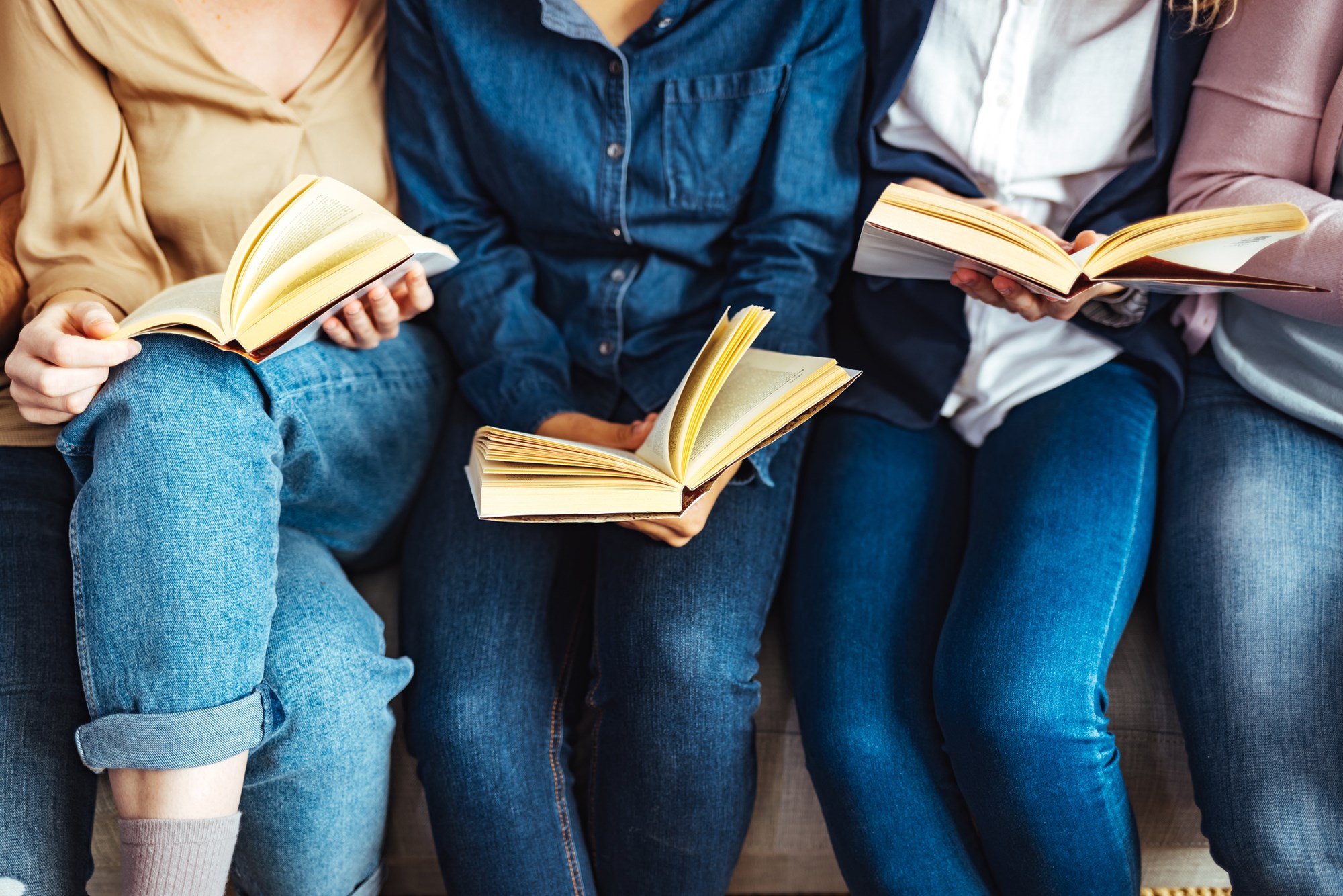 Close Up of Four Women Reading Together