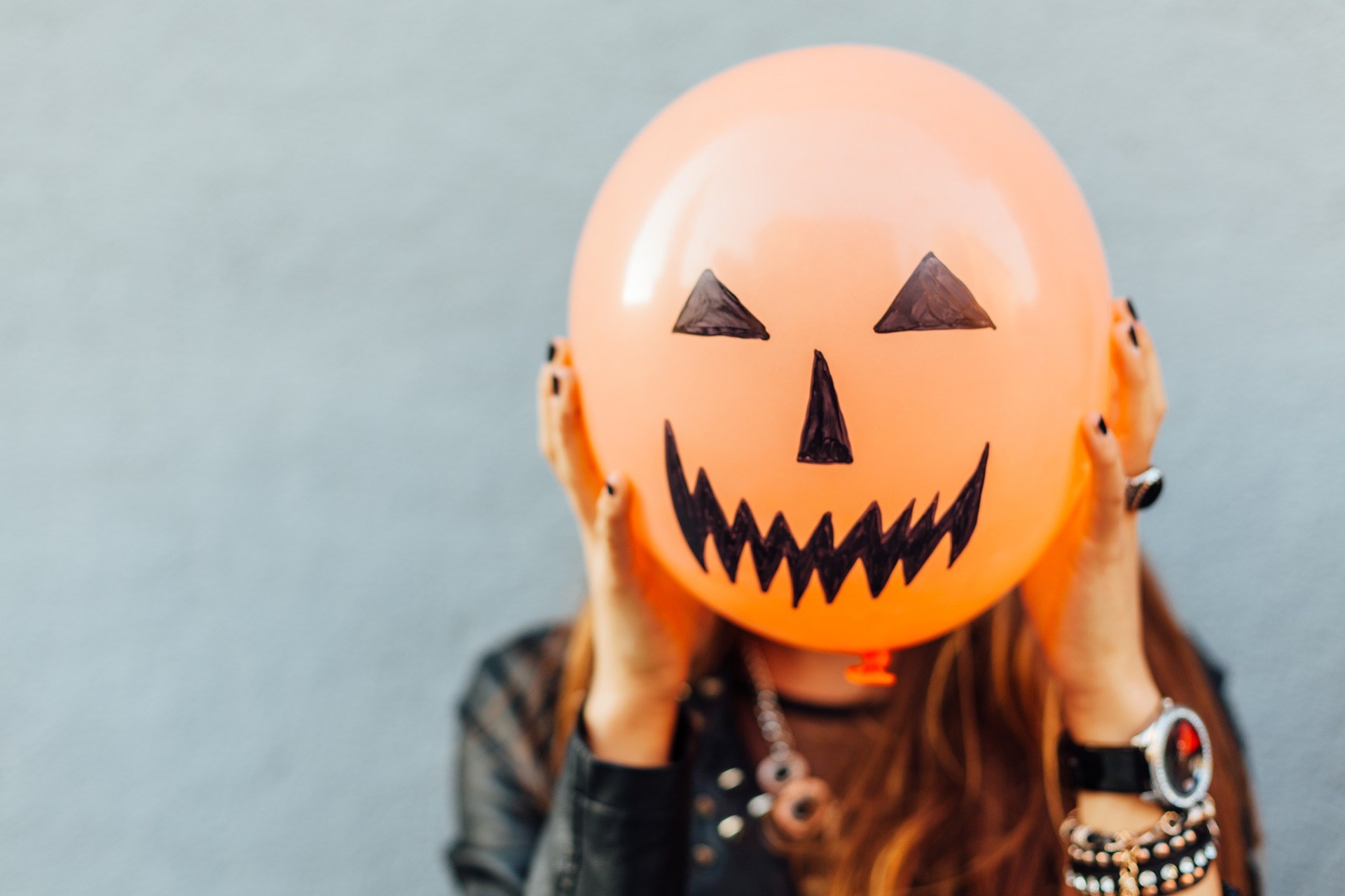 Holding a Jack O'Lantern Balloon