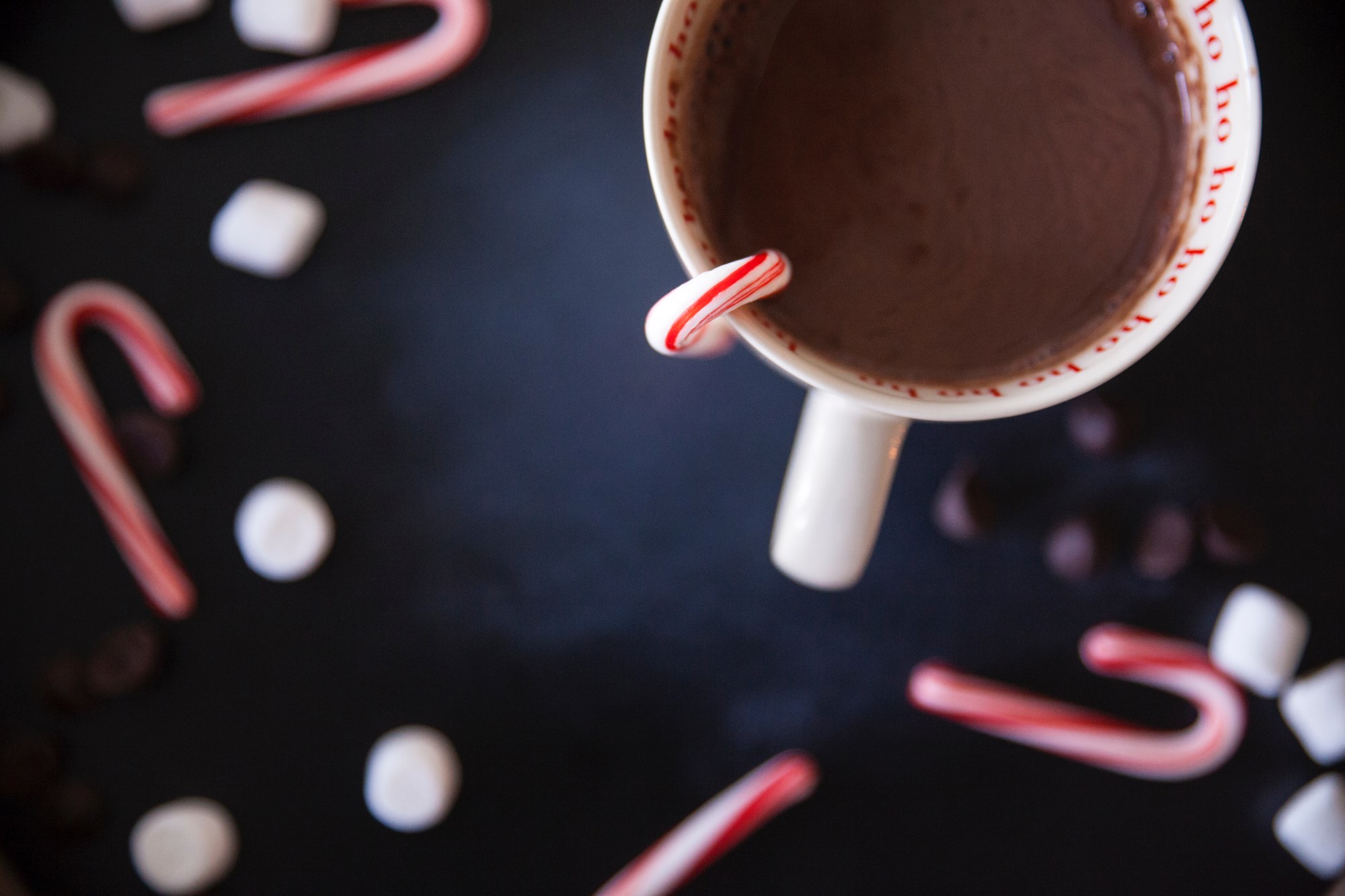 Holding a Mug of Cocoa in Front of Books