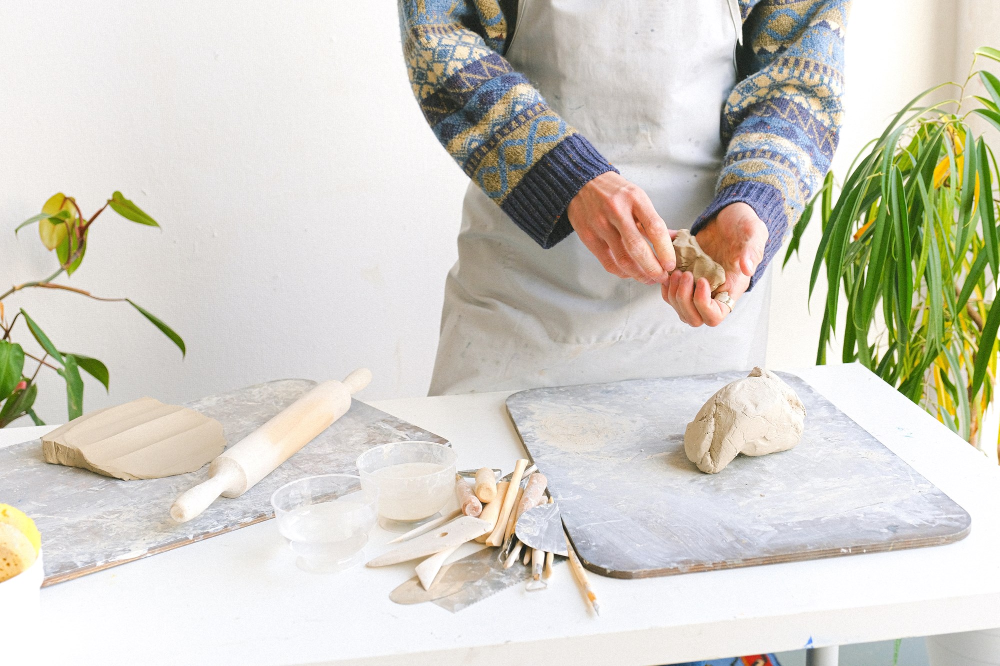 Person Molding Clay in Their Hands