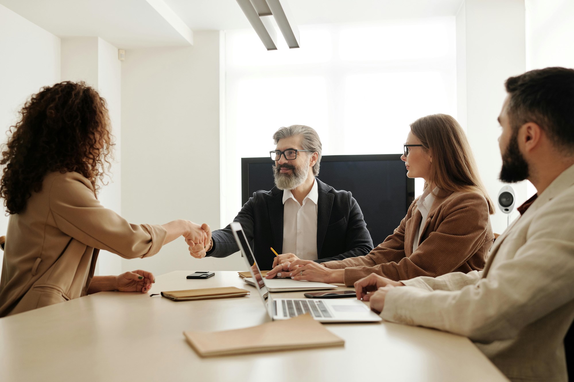 A Group of People Sitting at the Table at a Business Meeting