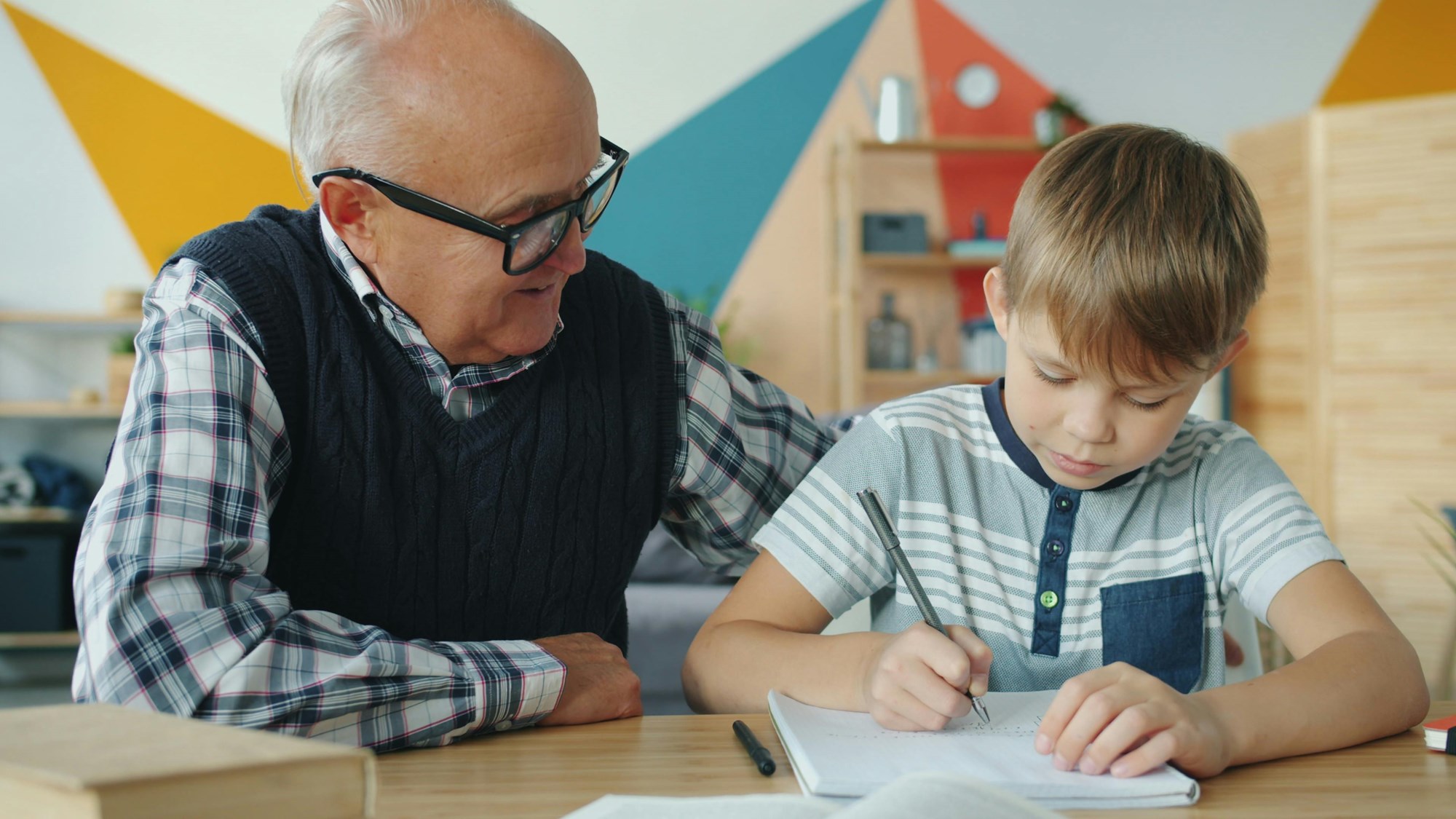 Grandfather Helping Grandson with Homework