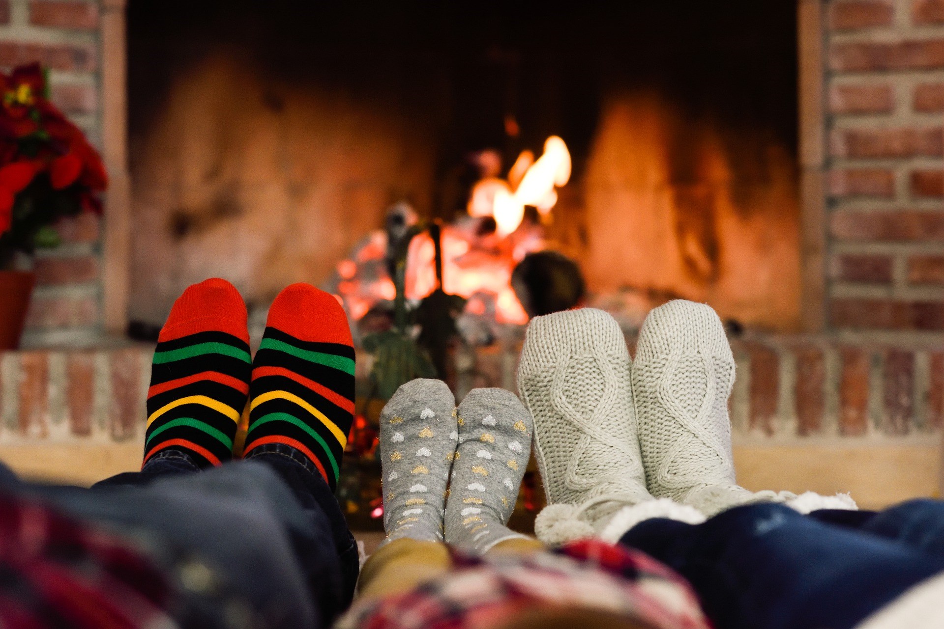 Family Wearing Cozy Socks by a Fireplace