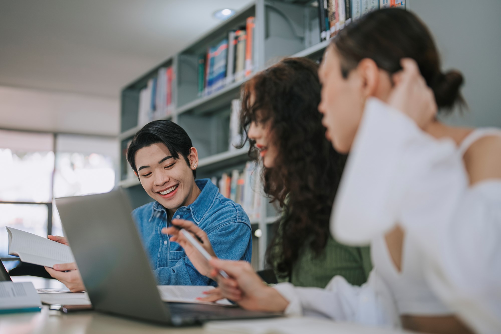 Three Students Studying in Library Together