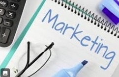 Desktop with Marketing plan notebook