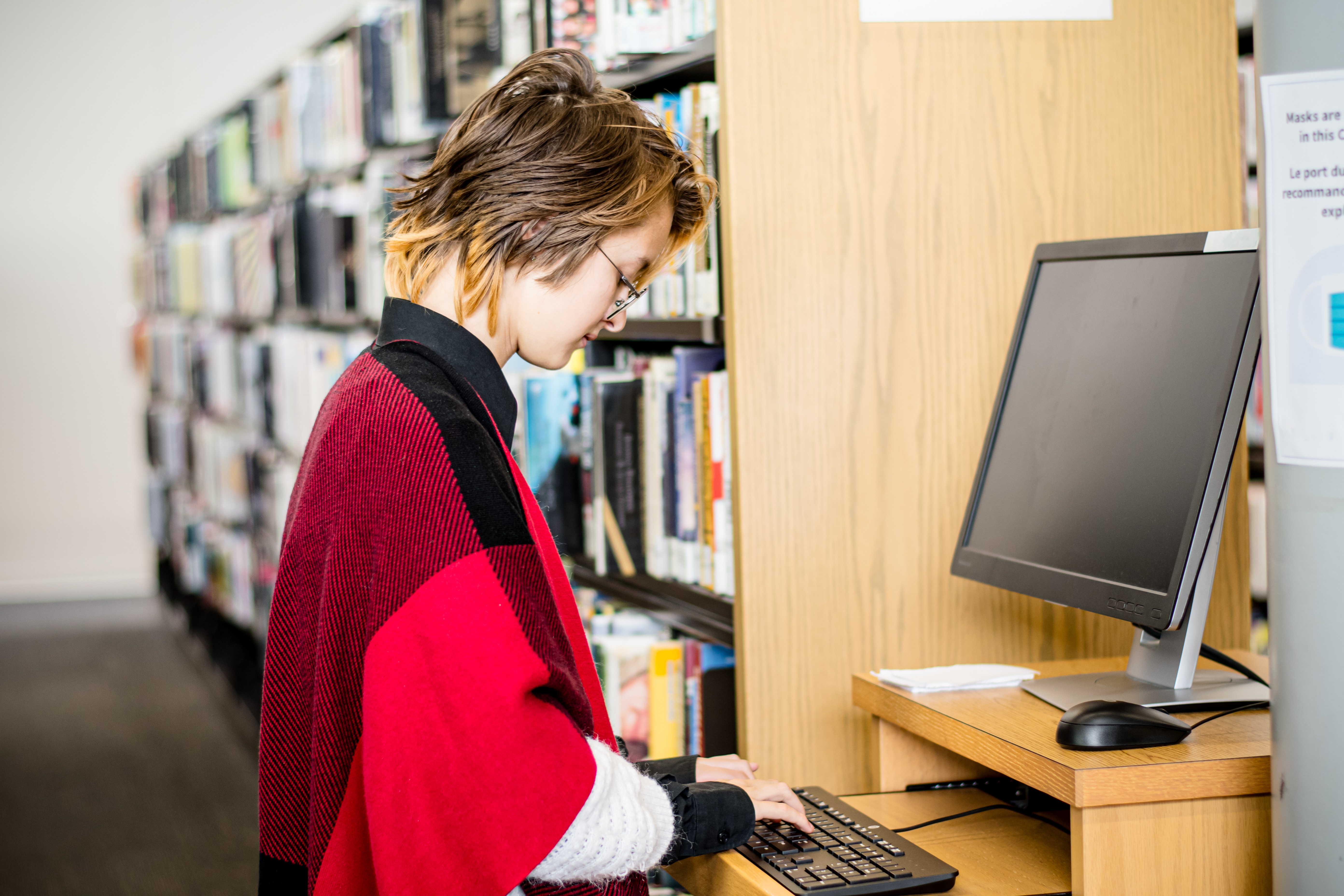 Teen Girl Navigates Information on Library Computer