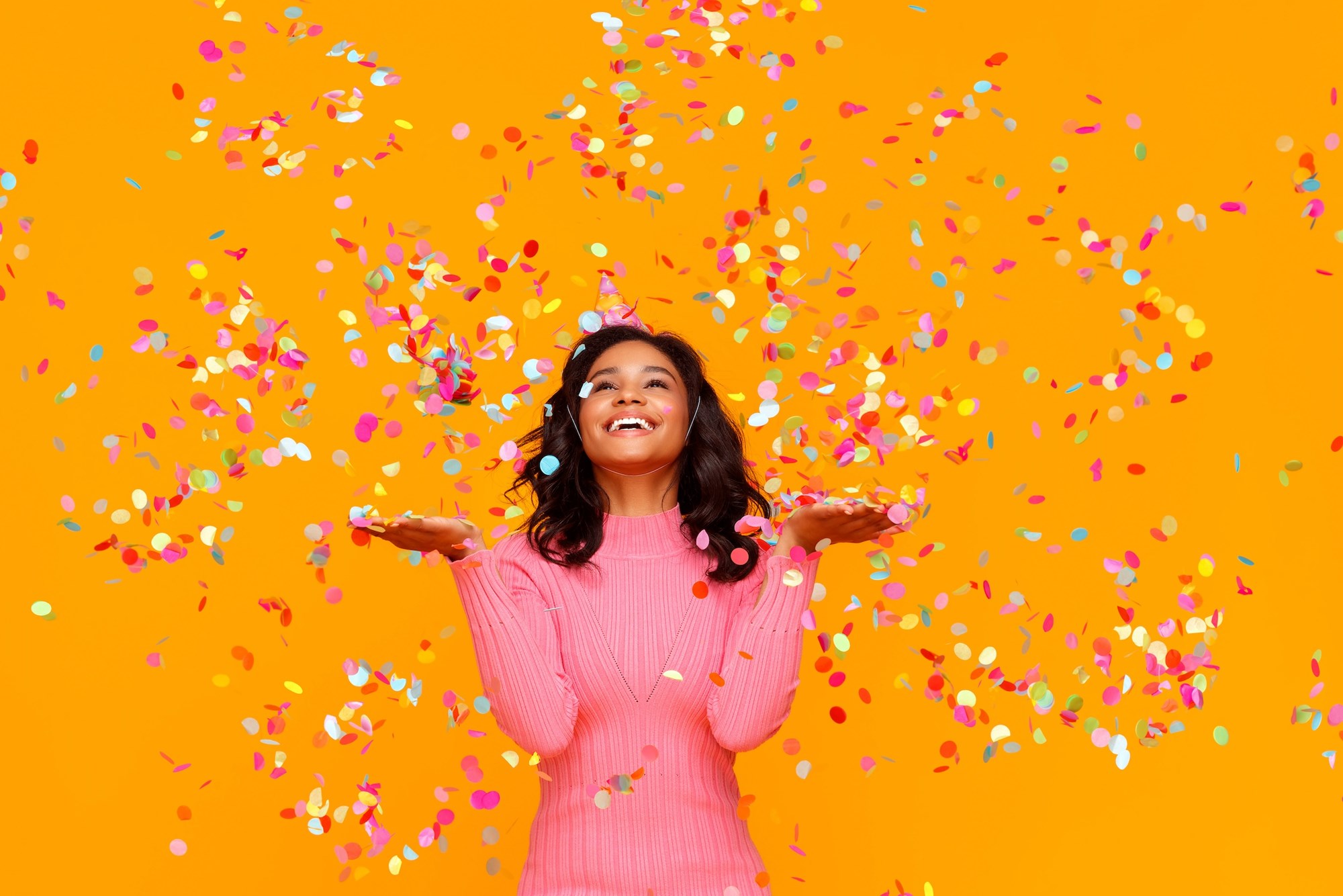 Two women in front of laptop in a library