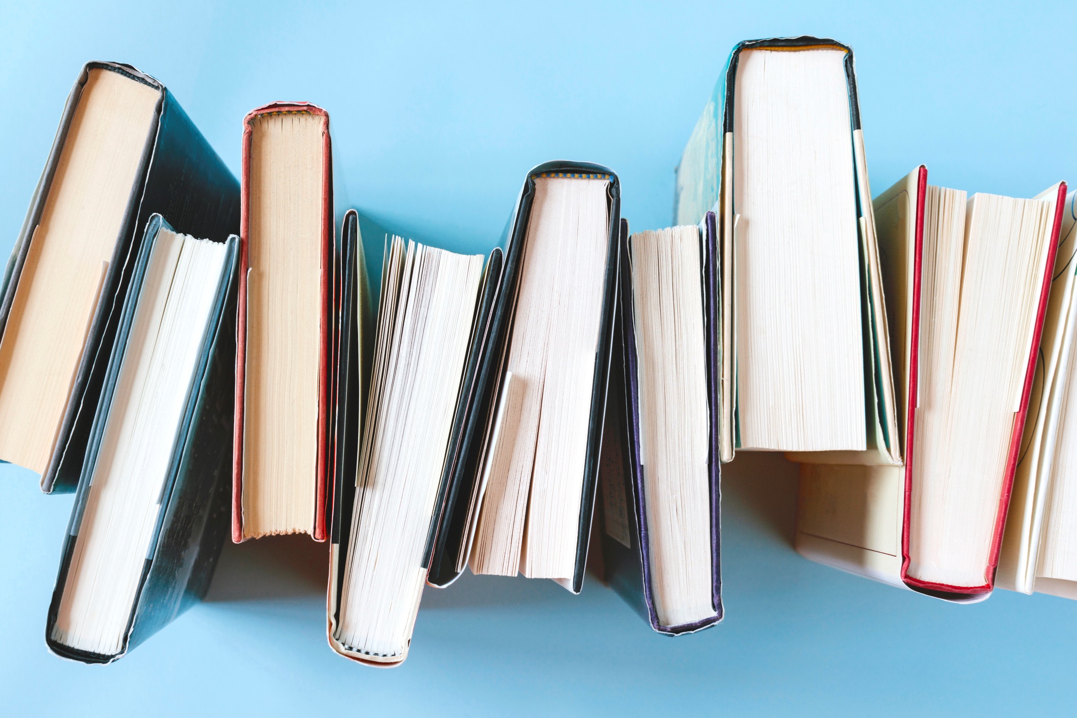 Person Holding a White Pencil While Using Laptop
