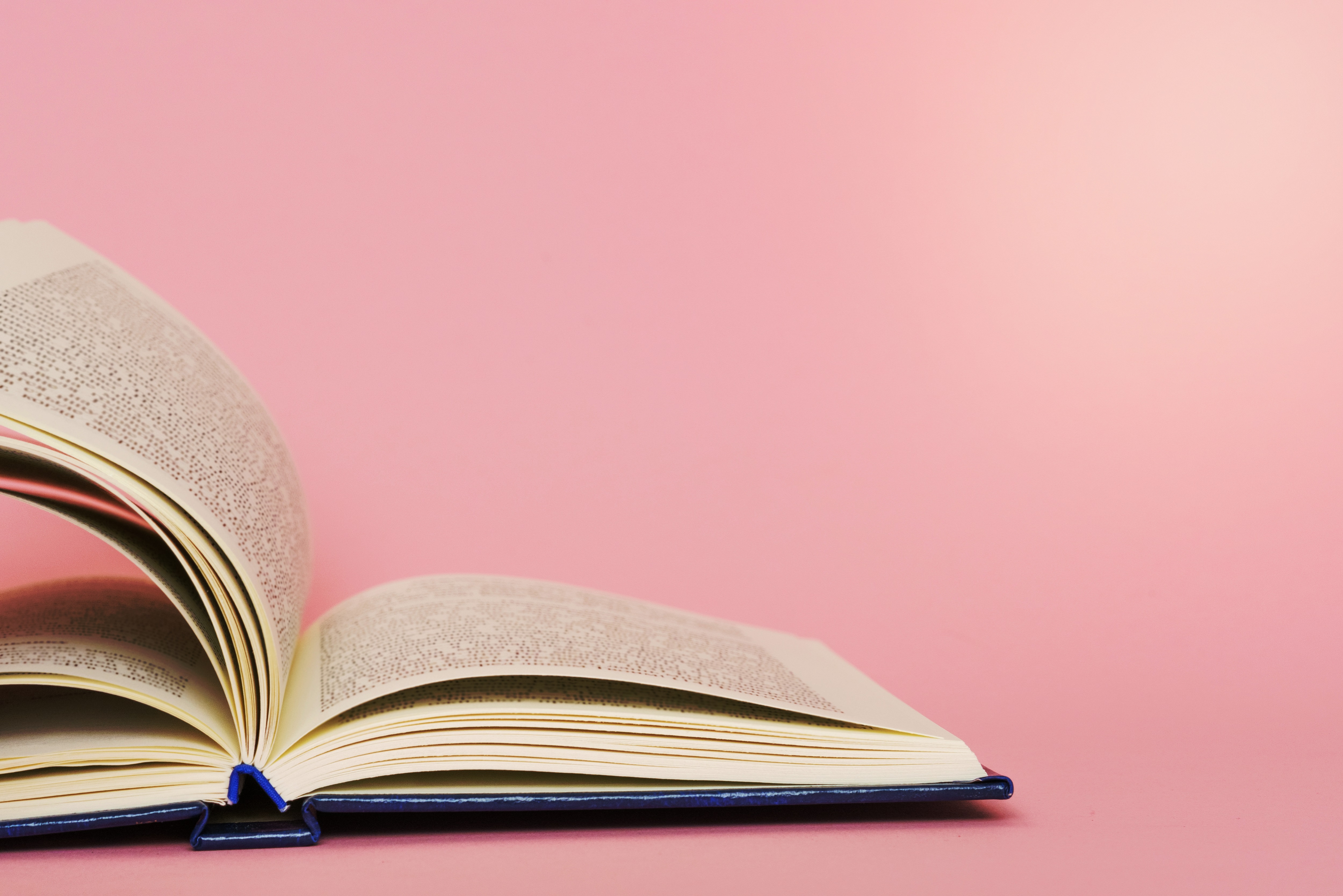 Open Book on Pink Background