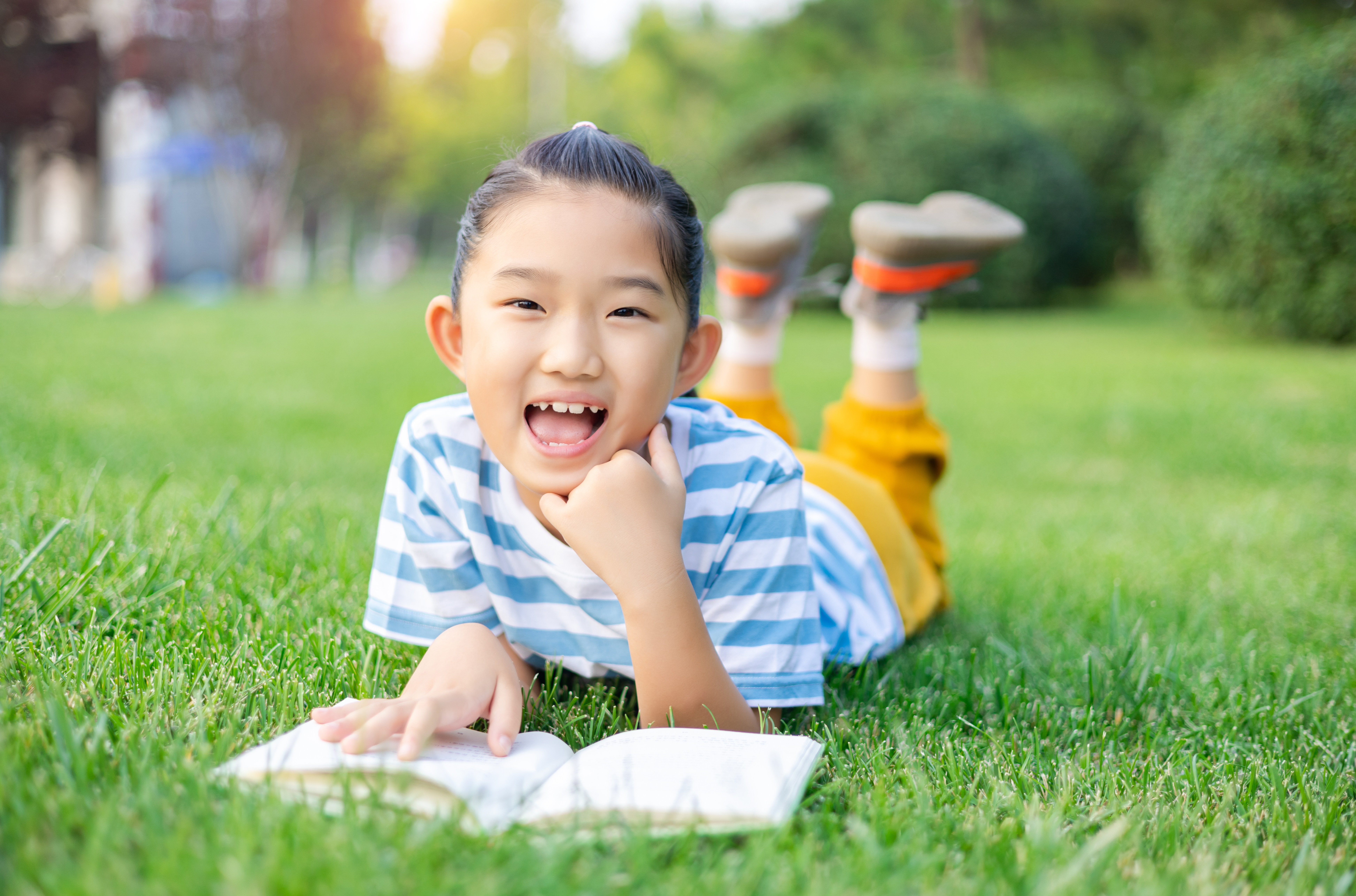 Little Girl Lying Down on Lawn