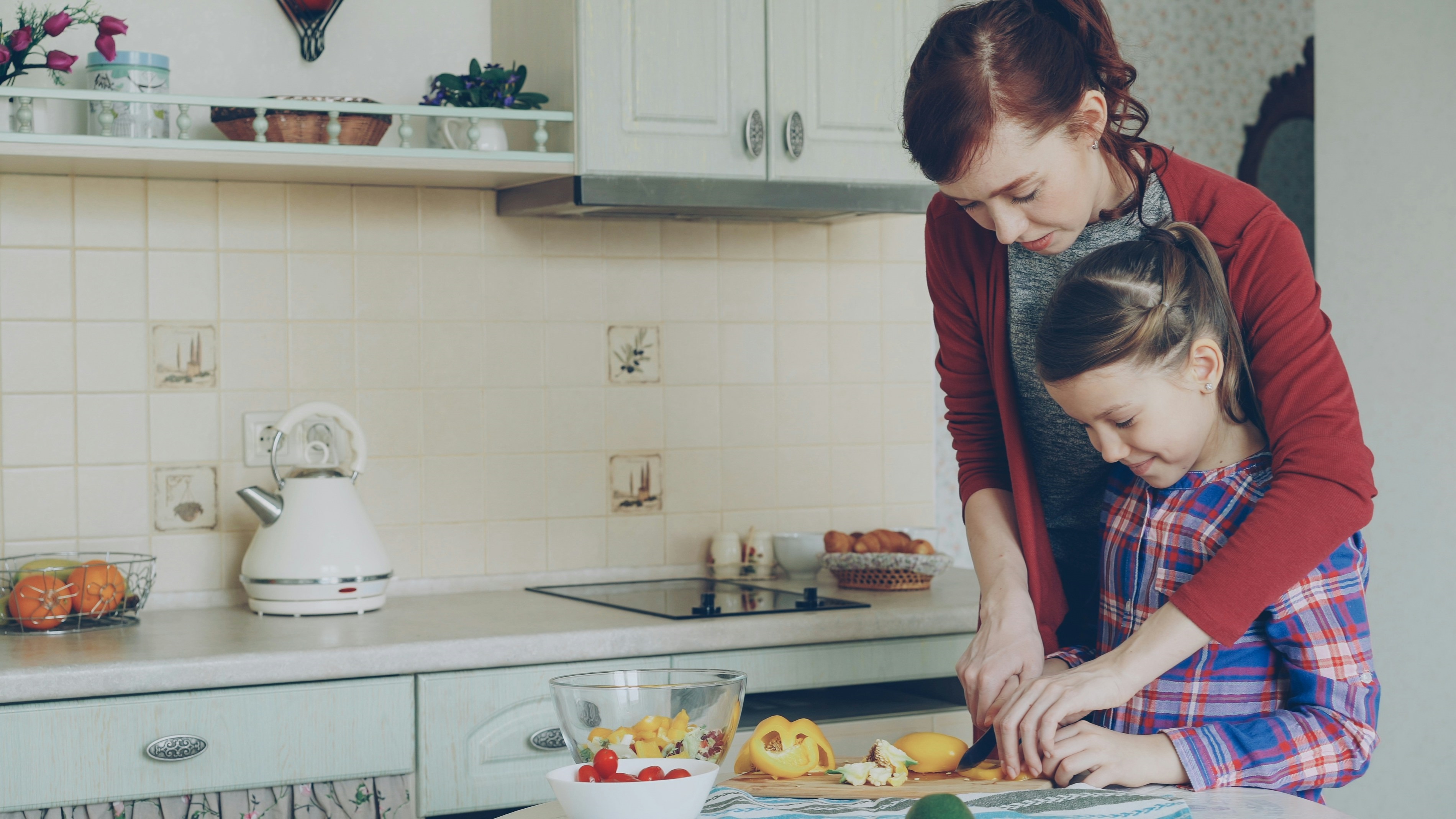Mother and Daughter Cook Food Together in the Kitchen