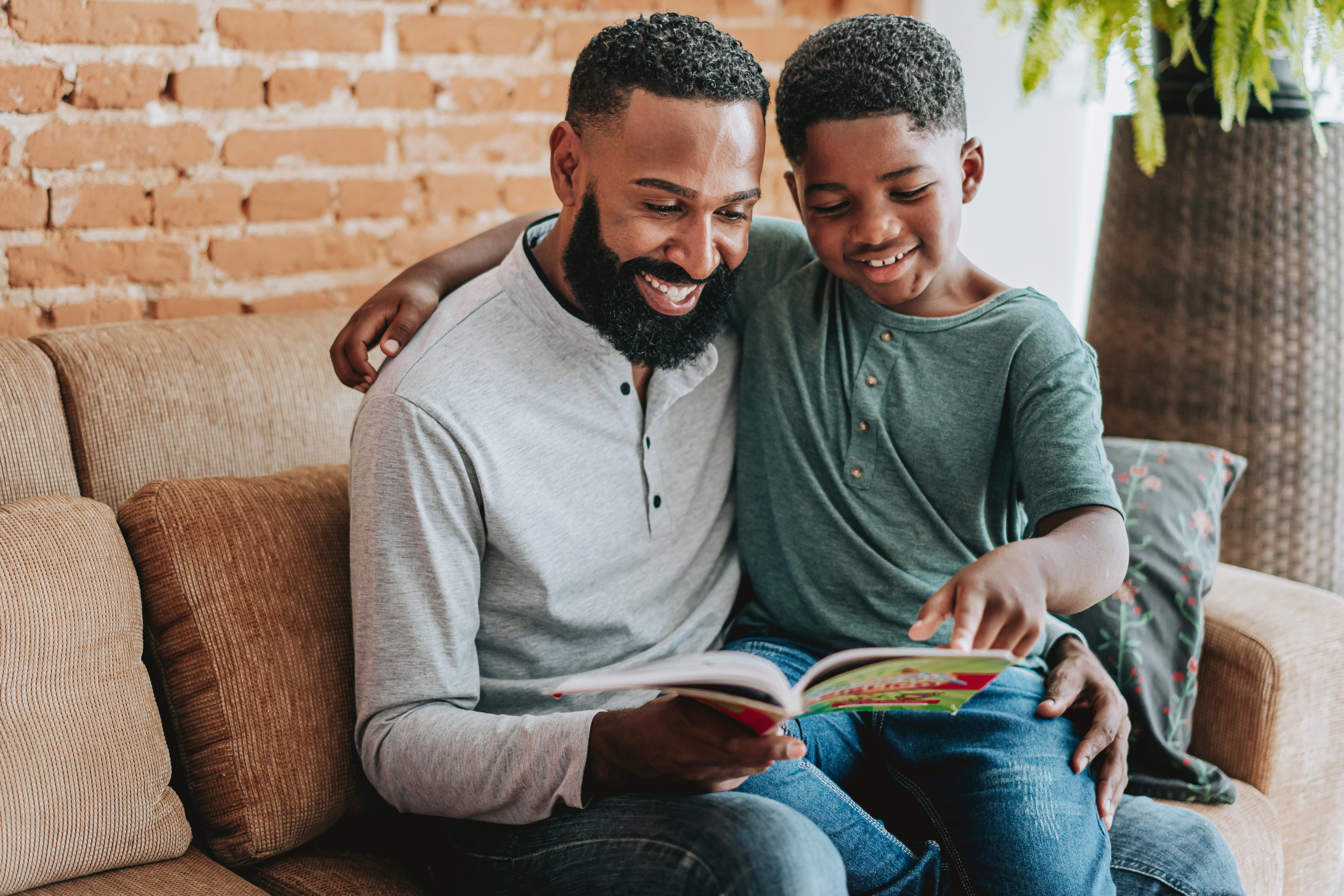 Father Reading A Book With Son Toddler Boy