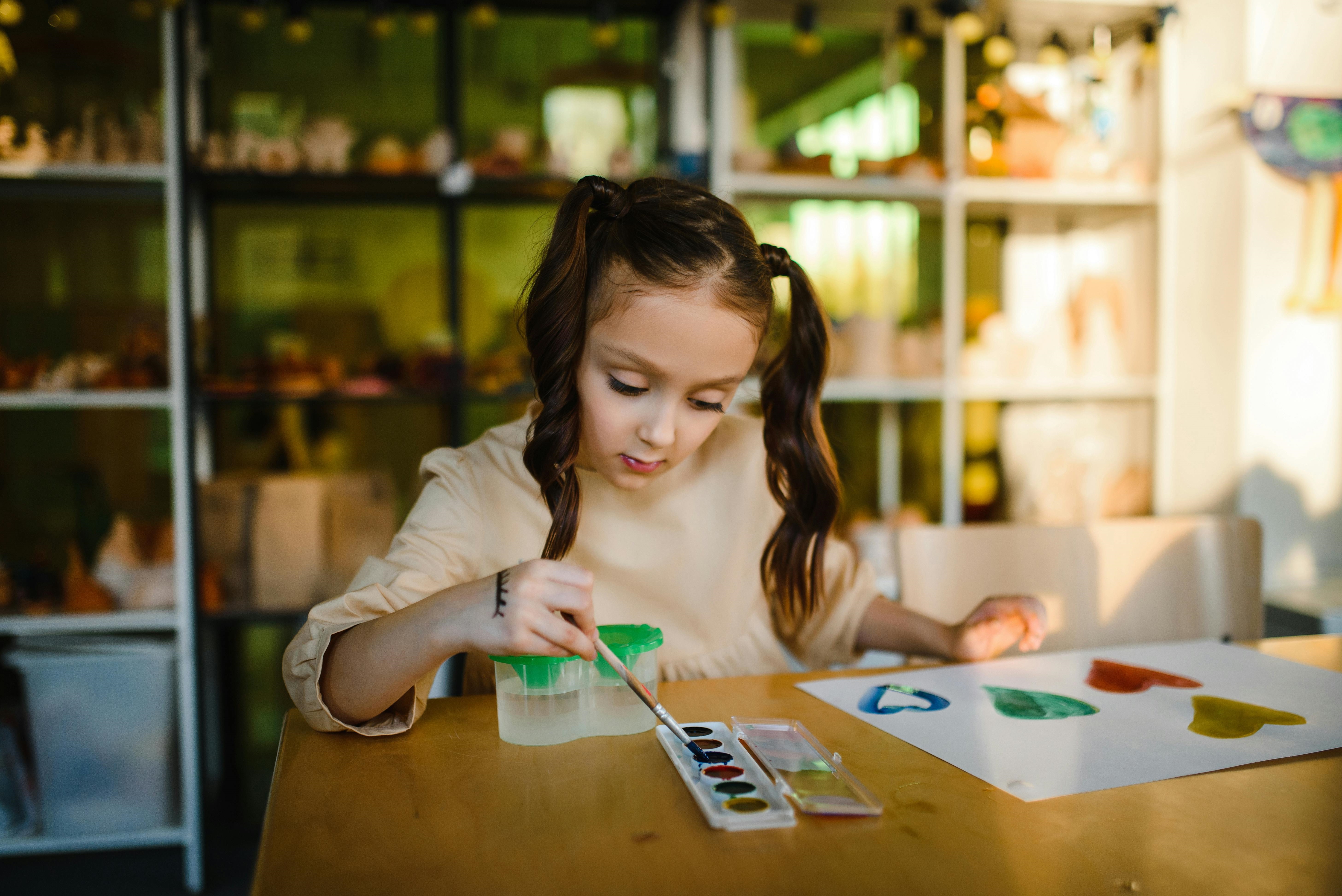 A Girl Painting on a Paper