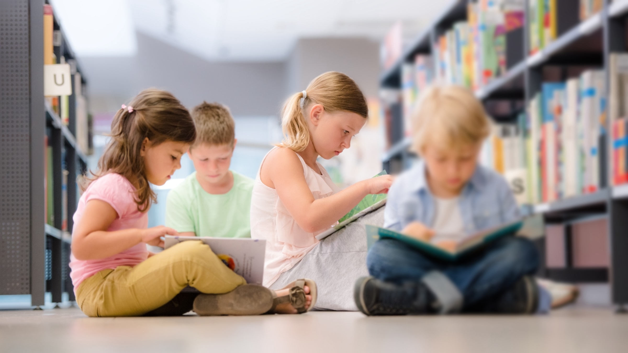 Group of Children Sitting on Floor and Reading Books