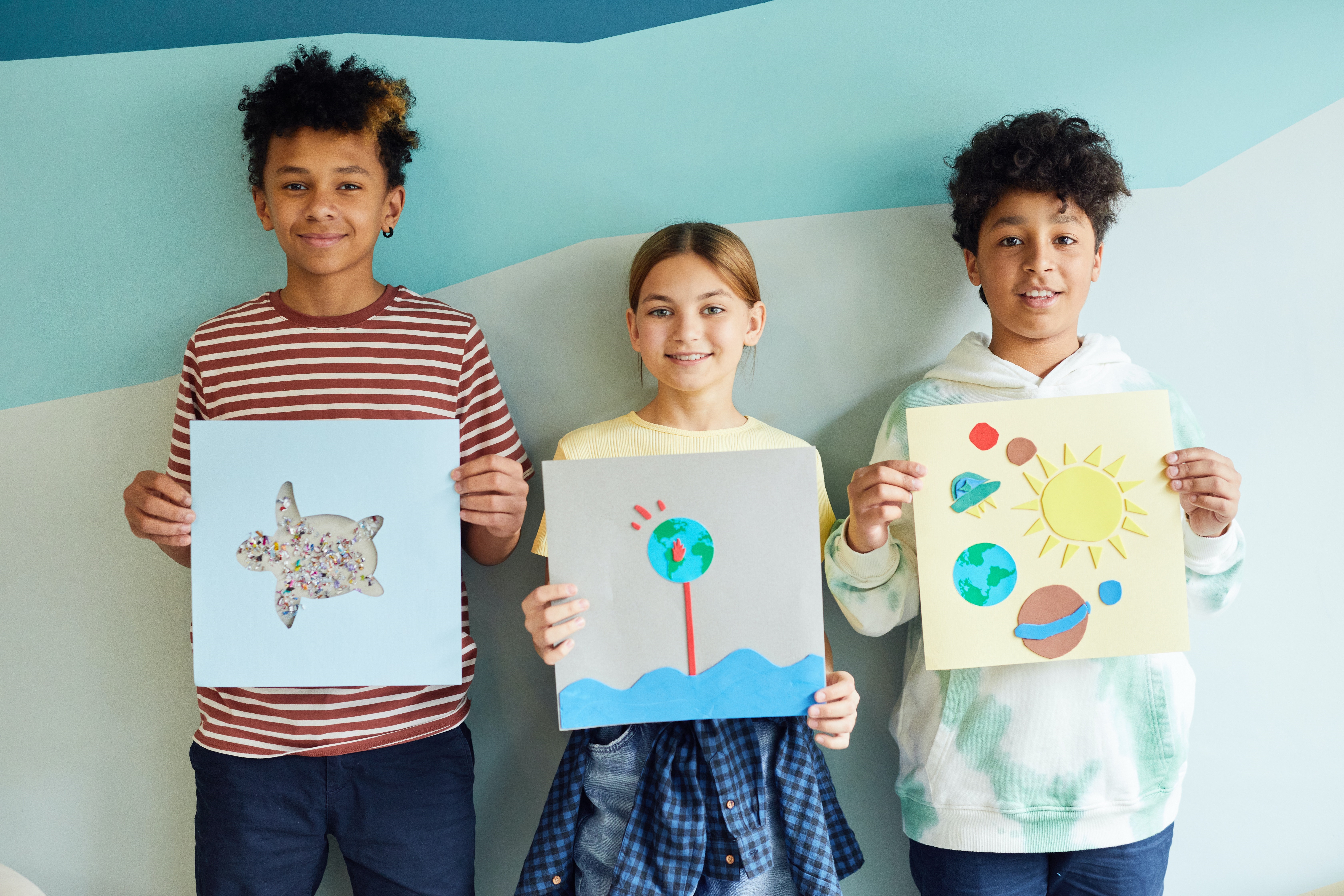 Young Students Holding Their Art Projects
