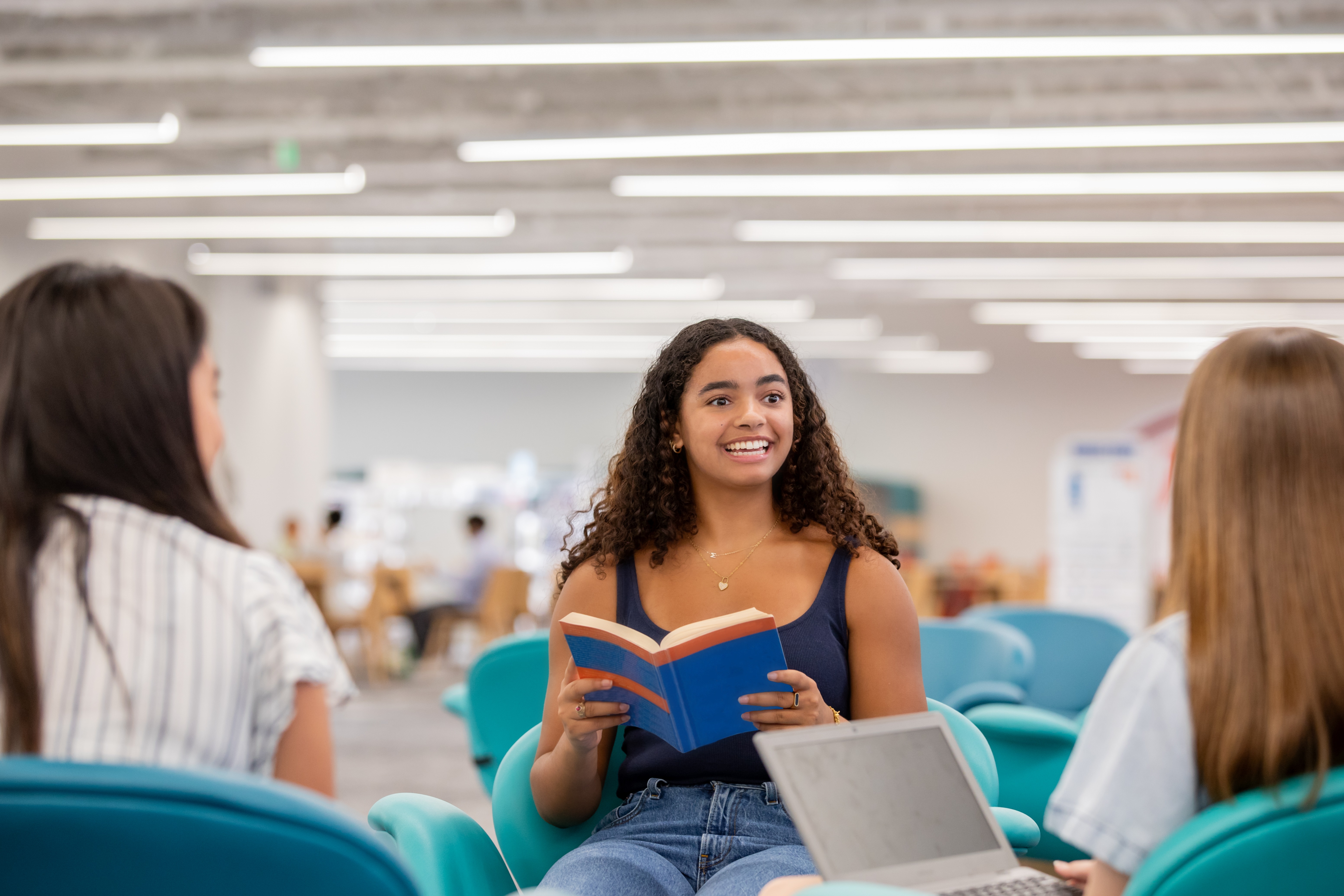 A Group Of Young Women Discussing Assignment In Study Session