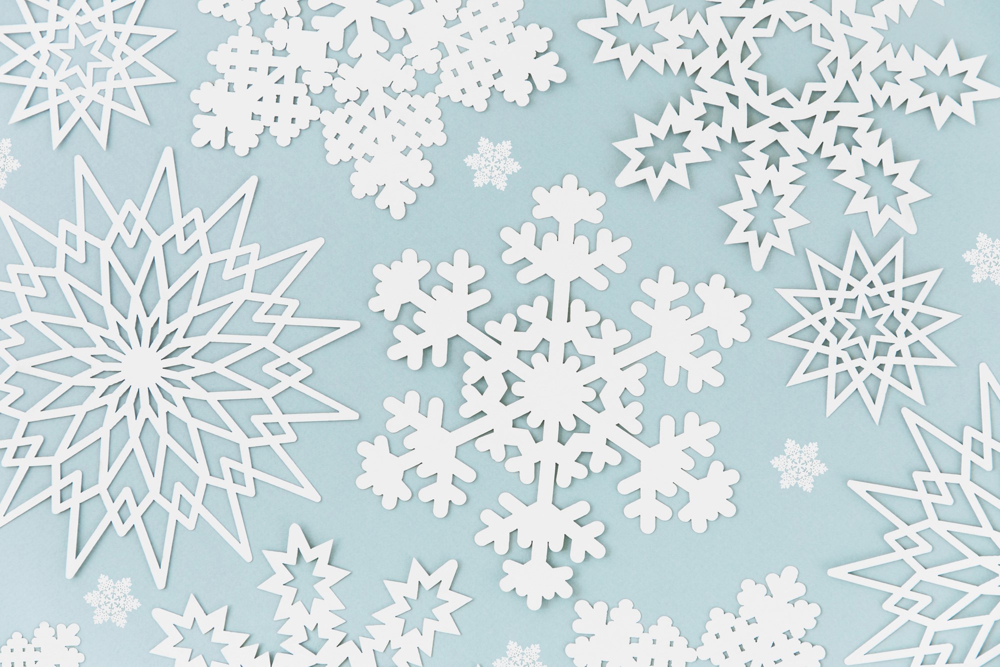 Paper Snowflakes on Blue Background