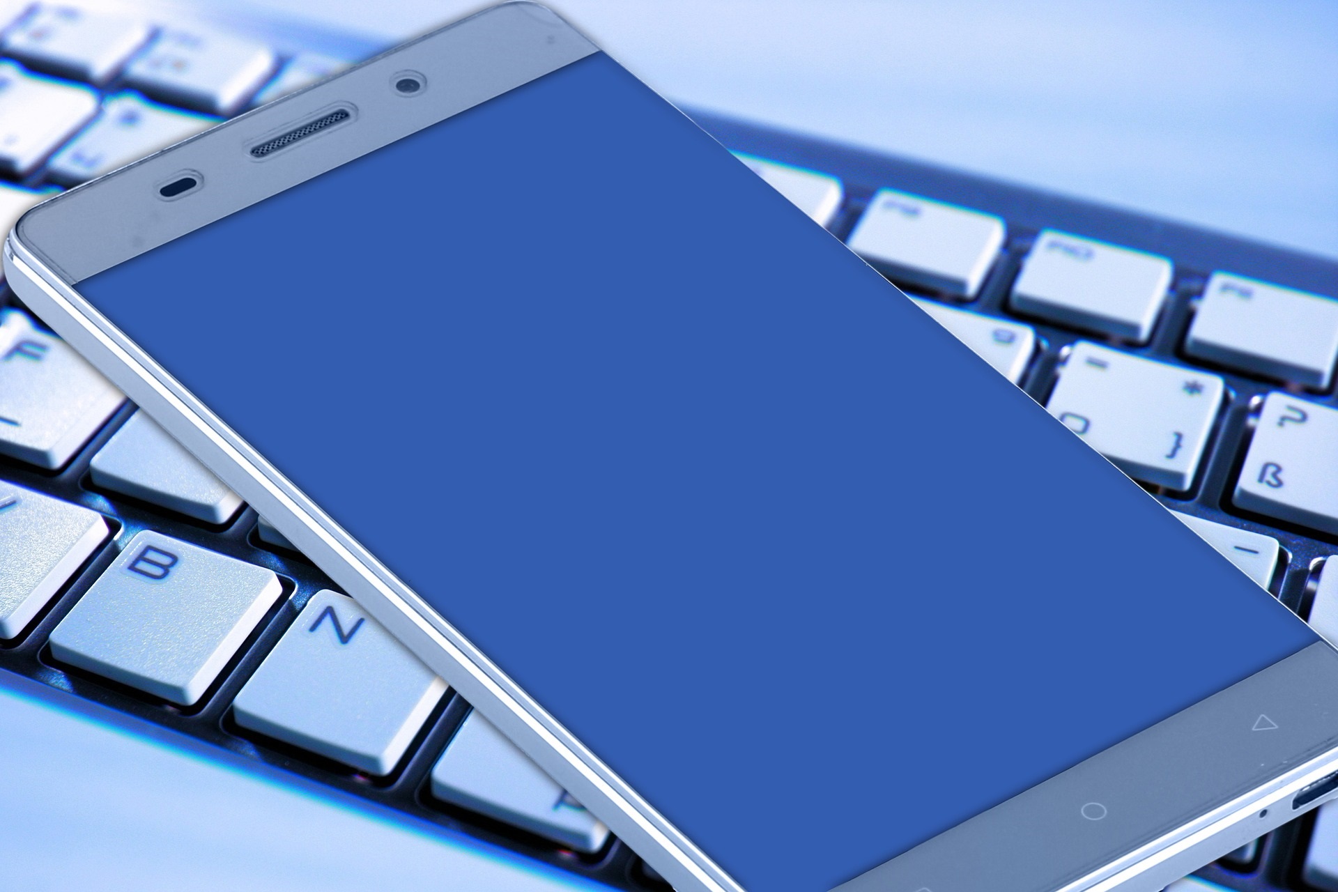 picture of a computer keyboard and a smart phone
