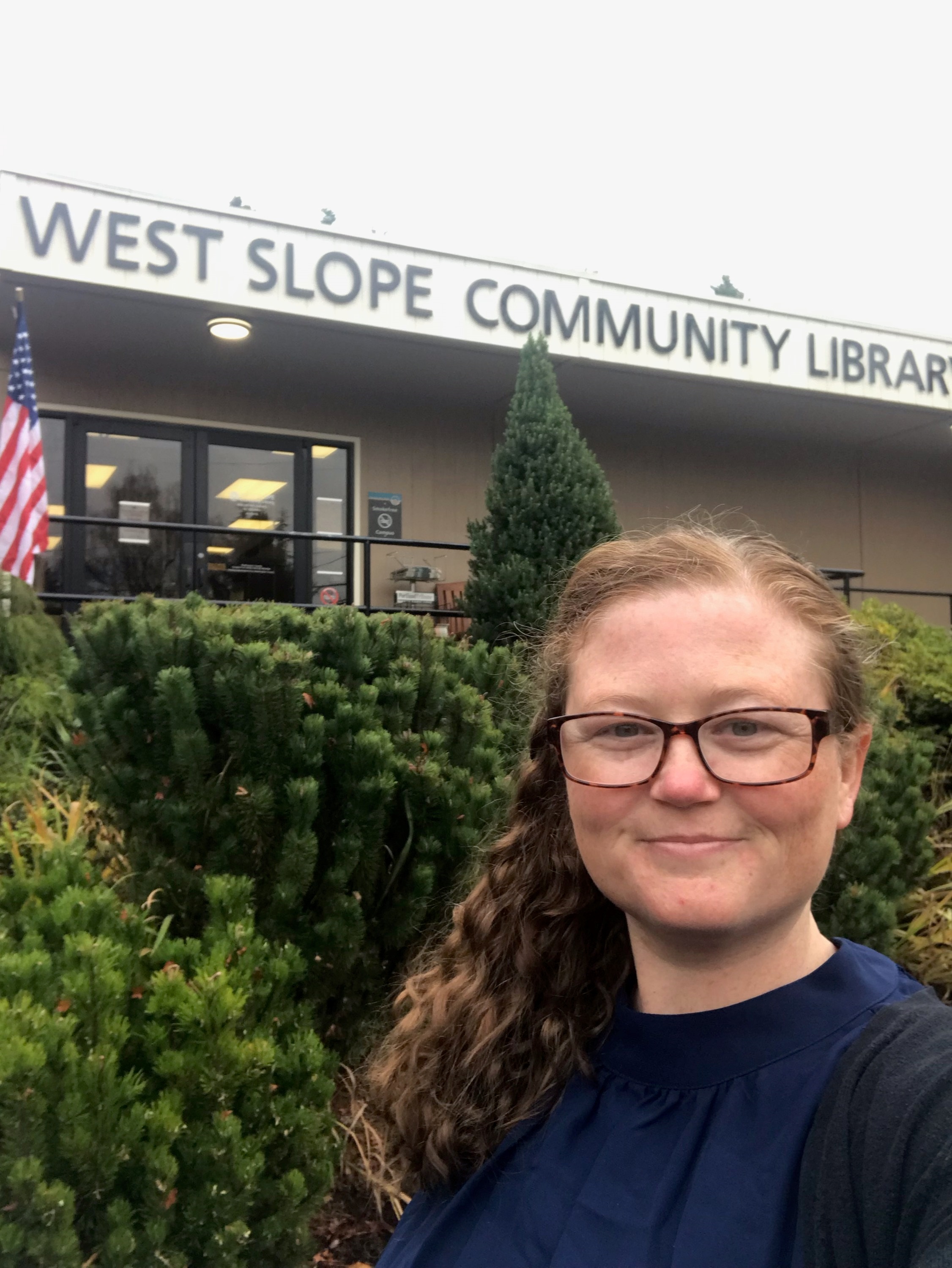Photo of Kristen Thorp in front of West Slope Library