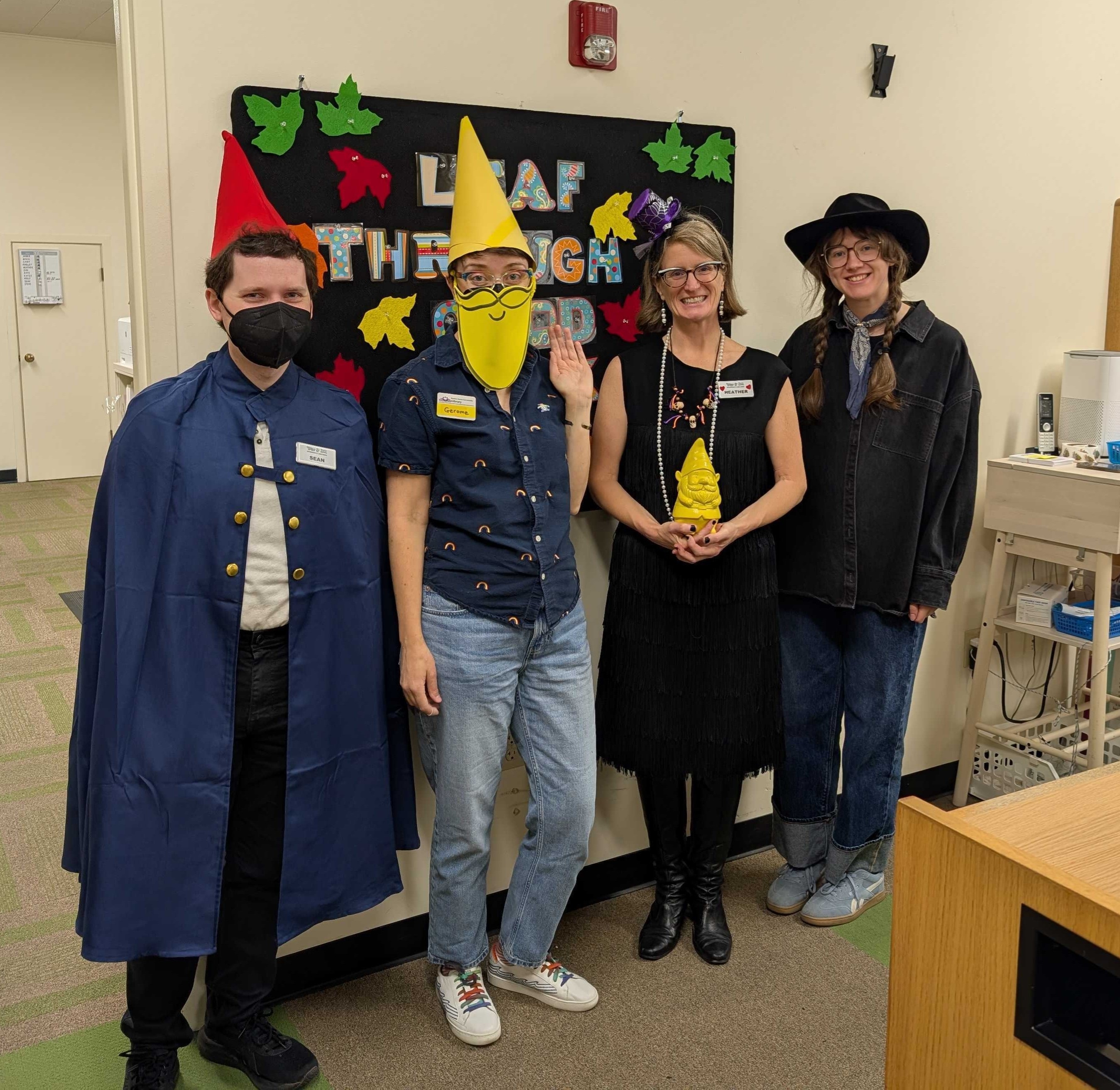 Photo of four people in Halloween costumes