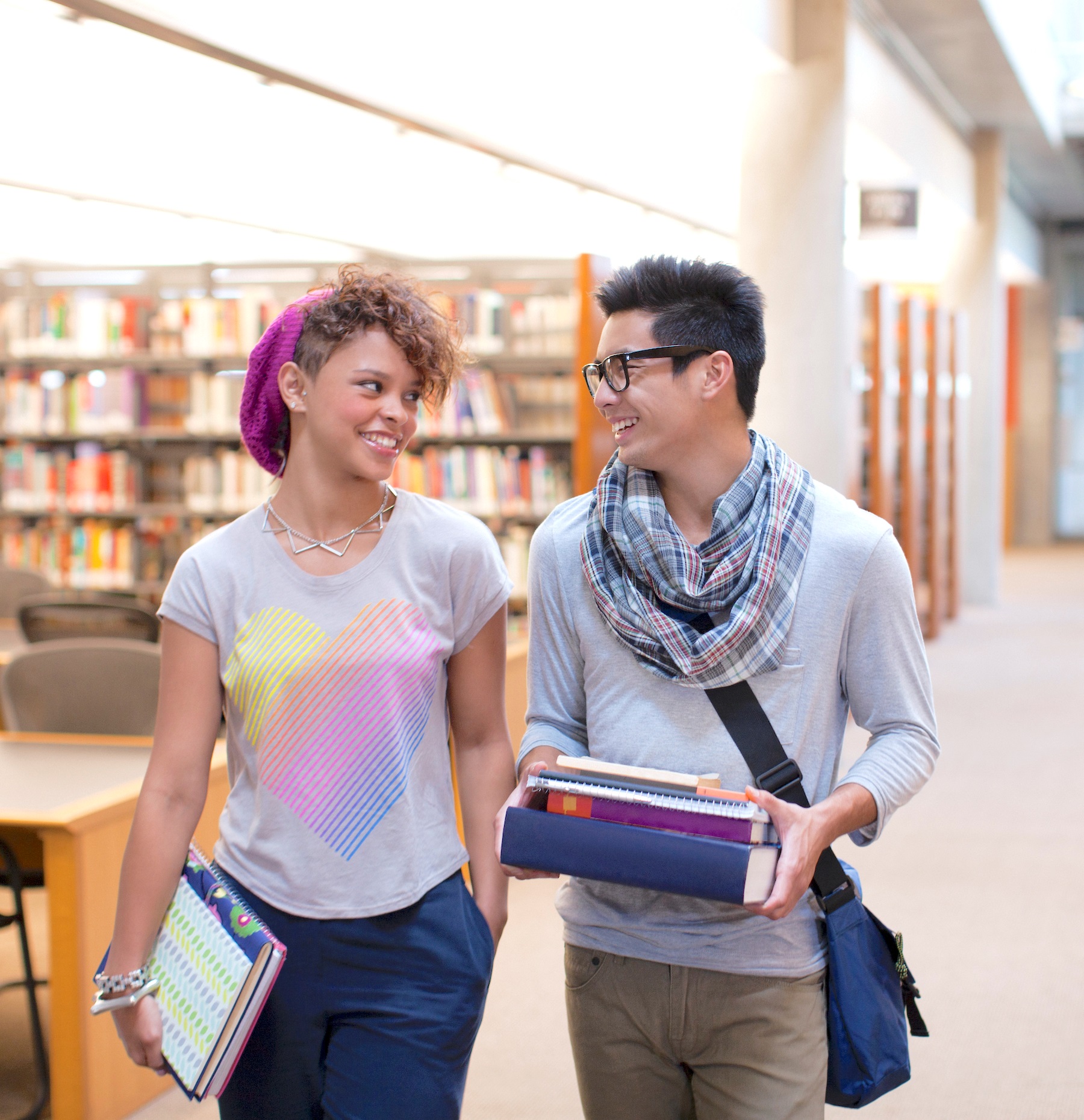 Two People Walking Through the Library
