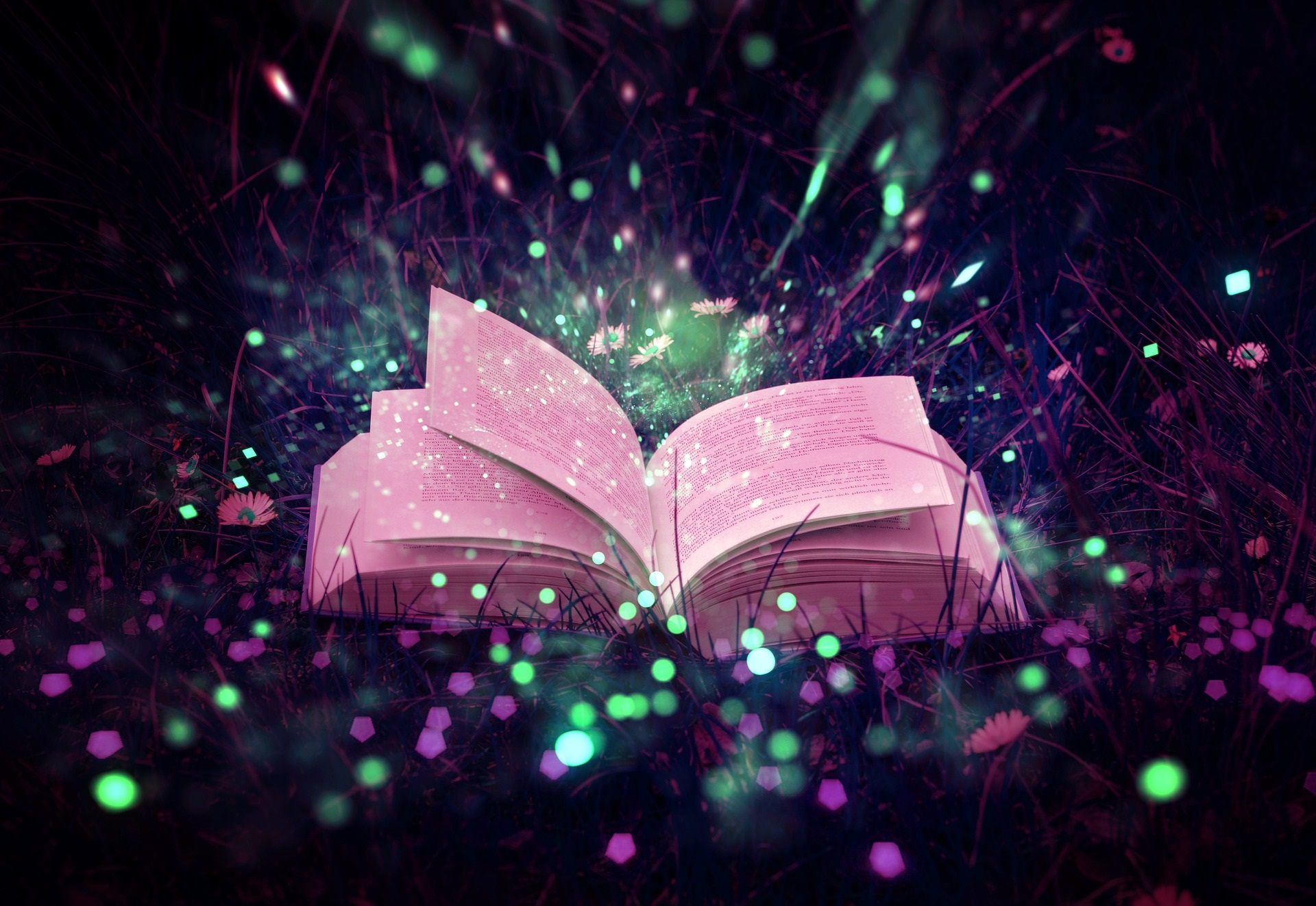 Magical open book glowing on grass