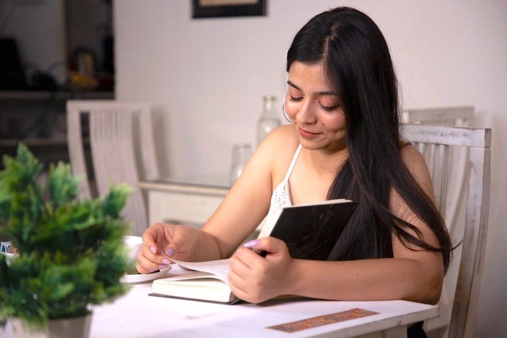 Woman seated at a table reading