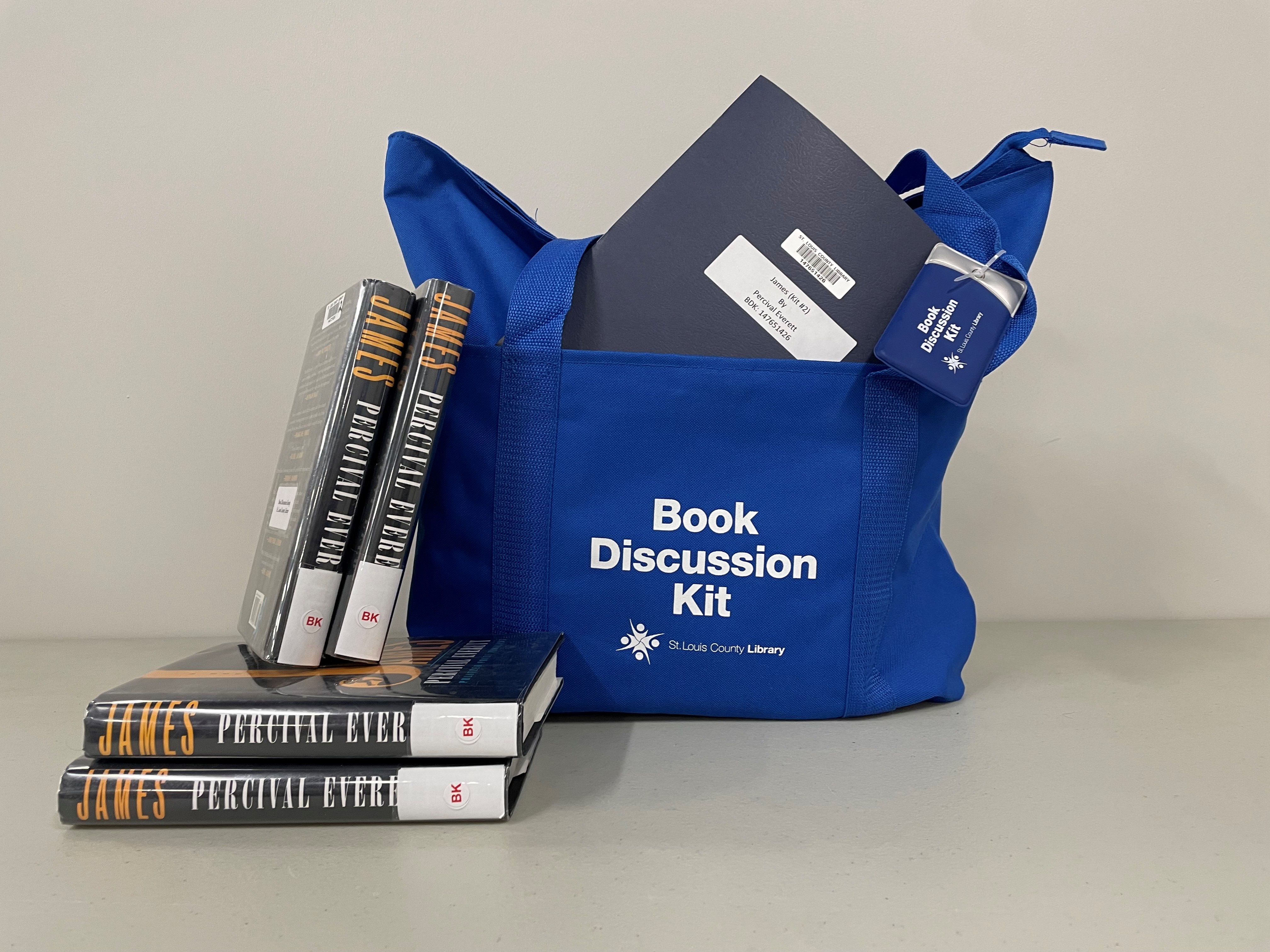 Photo of a Book Discussion Kit with blue bag, Discussion Guide, and books.