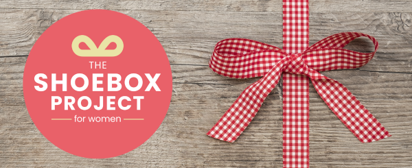 The Shoebox Project for Women inside a red circle, beside a gingham patterned bow.