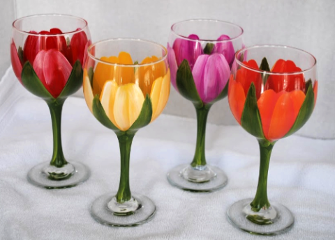 Four wine glasses painted to look like flowers