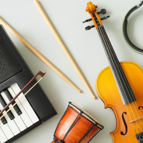 Various musical instruments including a violin, a drum, a keyboard, and drumsticks