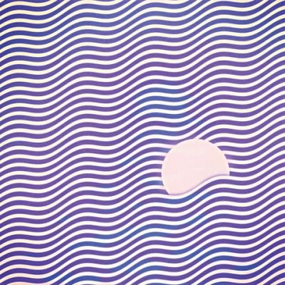 Album cover for "Waves" by Moonchild, featuring a soft, atmospheric design that reflects the album’s introspective and emotional tone. The artwork uses muted colors and abstract imagery suggestive of movement and flow.