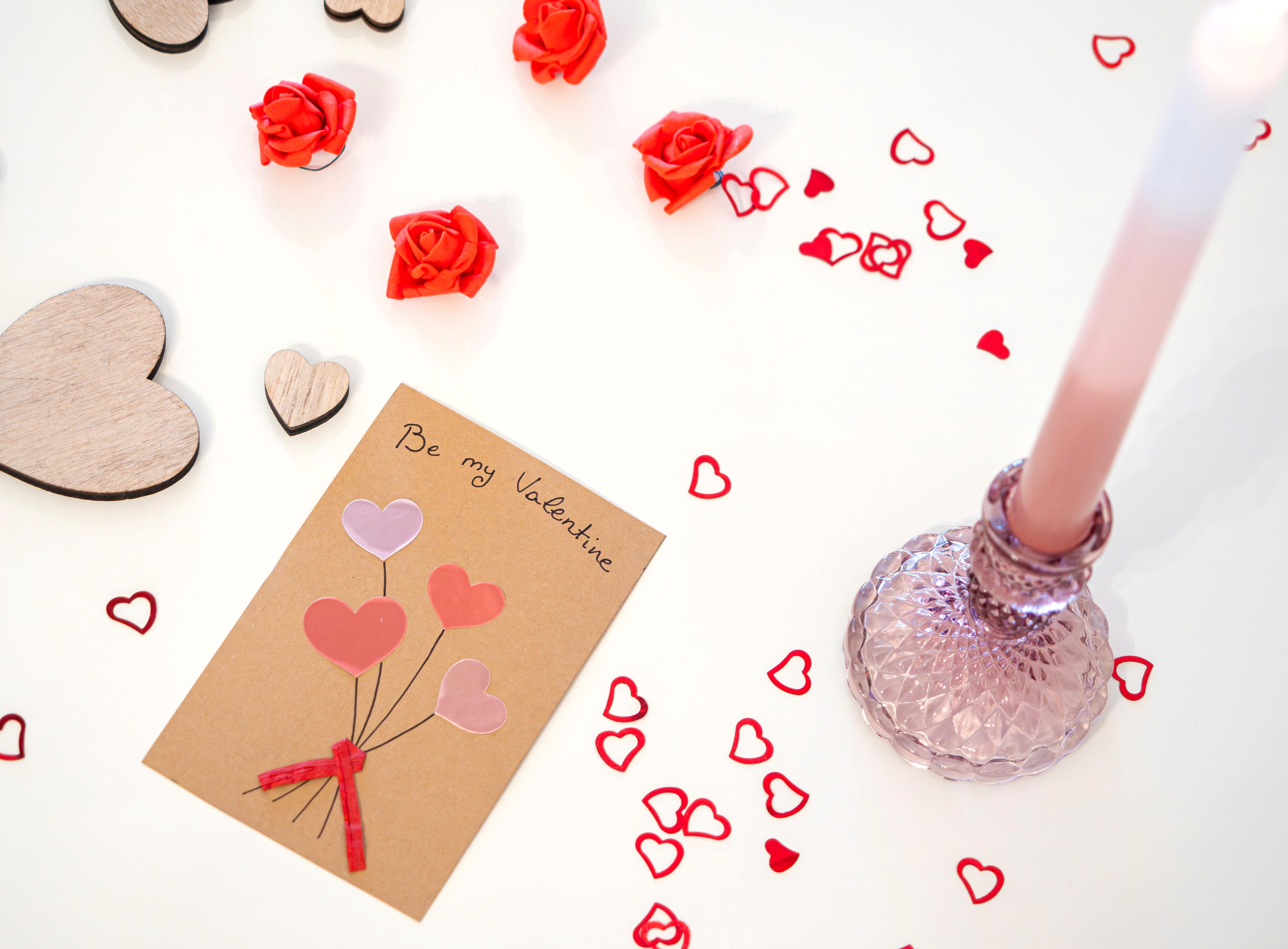 A Valentine's Day Card and a Candle on a Table